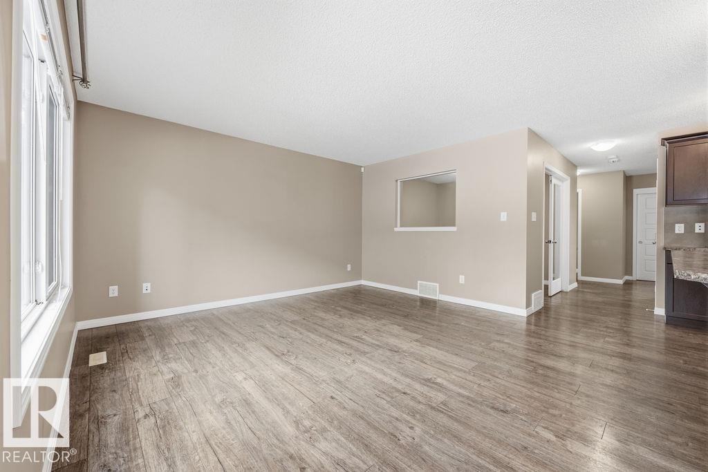 The room features light gray walls, a window with horizontal blinds, and gray carpeting - 7873 170A Avenue, Edmonton, AB - Indoor Photo Showing Other Room
