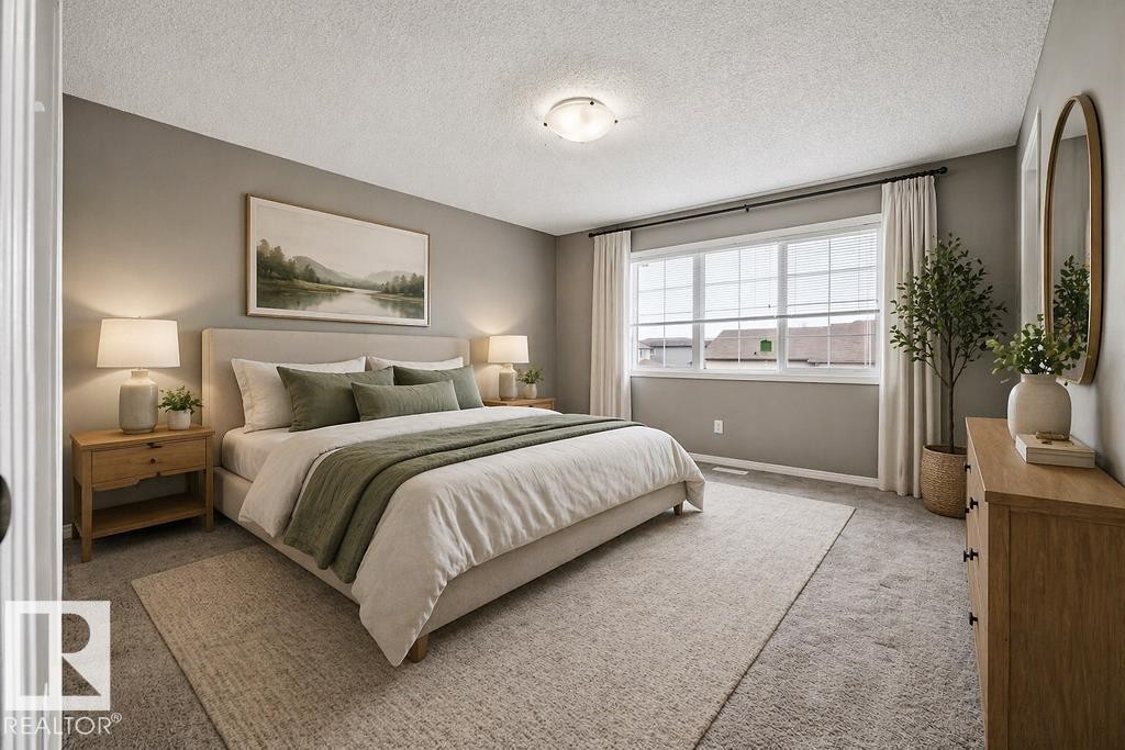 This bathroom features a double vanity with dark wood cabinetry and a large mirror - 7873 170A Avenue, Edmonton, AB - Indoor Photo Showing Bathroom