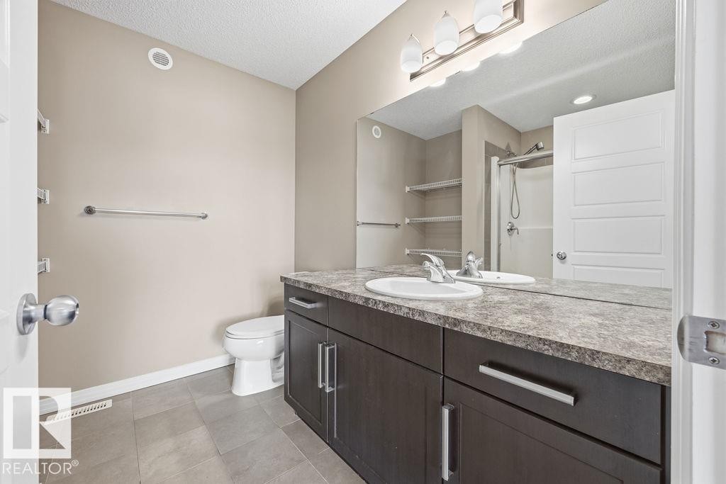 Hallway with light-colored walls, white trim, and carpeted flooring - 7873 170A Avenue, Edmonton, AB - Indoor Photo Showing Other Room