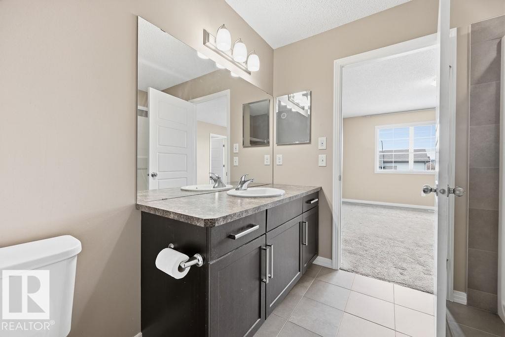 This room features plush grey carpeting, light neutral wall paint, and a window providing natural light - 7873 170A Avenue, Edmonton, AB - Indoor Photo Showing Other Room