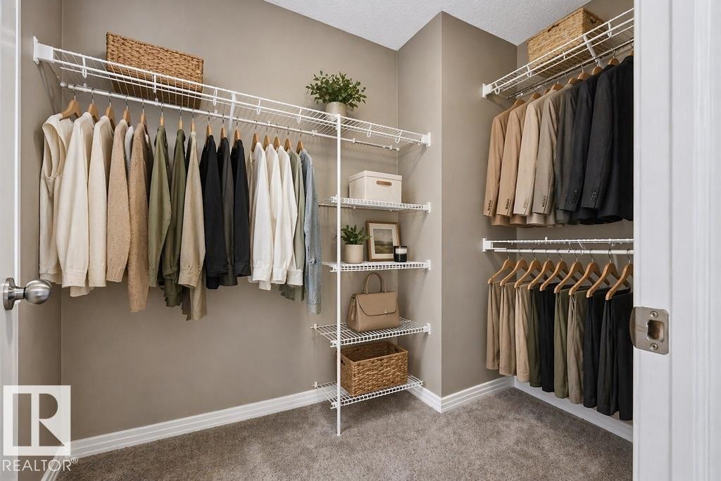 Bathroom featuring a double vanity with ample counter space, a large mirror, and a combination shower and tub with a shower curtain rod - 7873 170A Avenue, Edmonton, AB - Indoor Photo Showing Bathroom