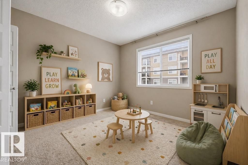 Property entrance featuring a dark front door, stone facade accents, and light-colored siding - 7873 170A Avenue, Edmonton, AB - Outdoor