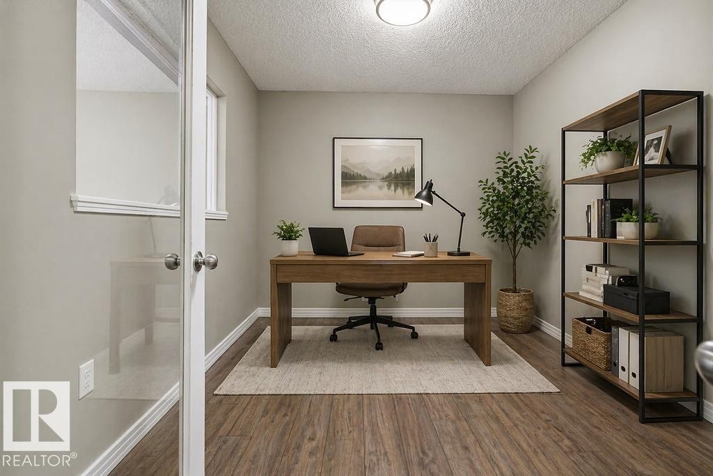 Room featuring wood-style flooring, light-colored walls, and a window - 7873 170A Avenue, Edmonton, AB - Indoor Photo Showing Other Room