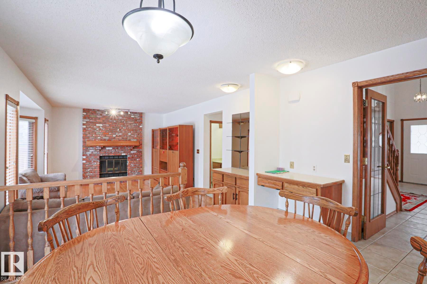 507 Burton Close, Edmonton, AB - Indoor Photo Showing Dining Room With Fireplace