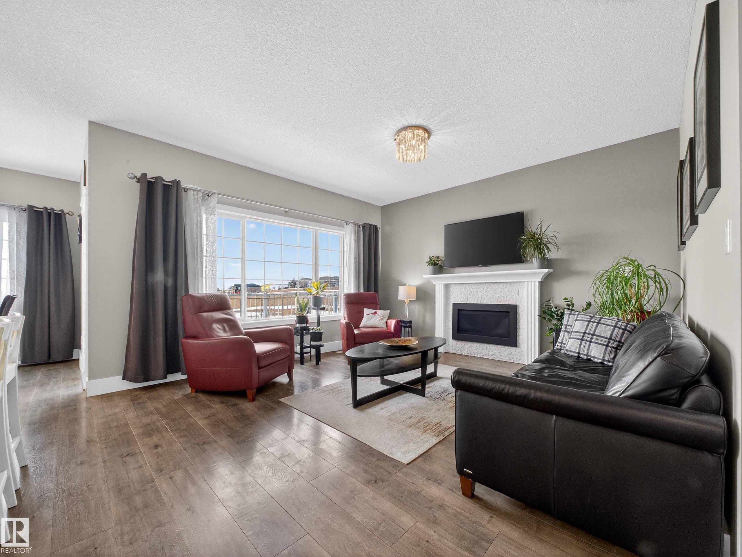1047 Coopers Hawk Link Link, Edmonton, AB - Indoor Photo Showing Living Room With Fireplace
