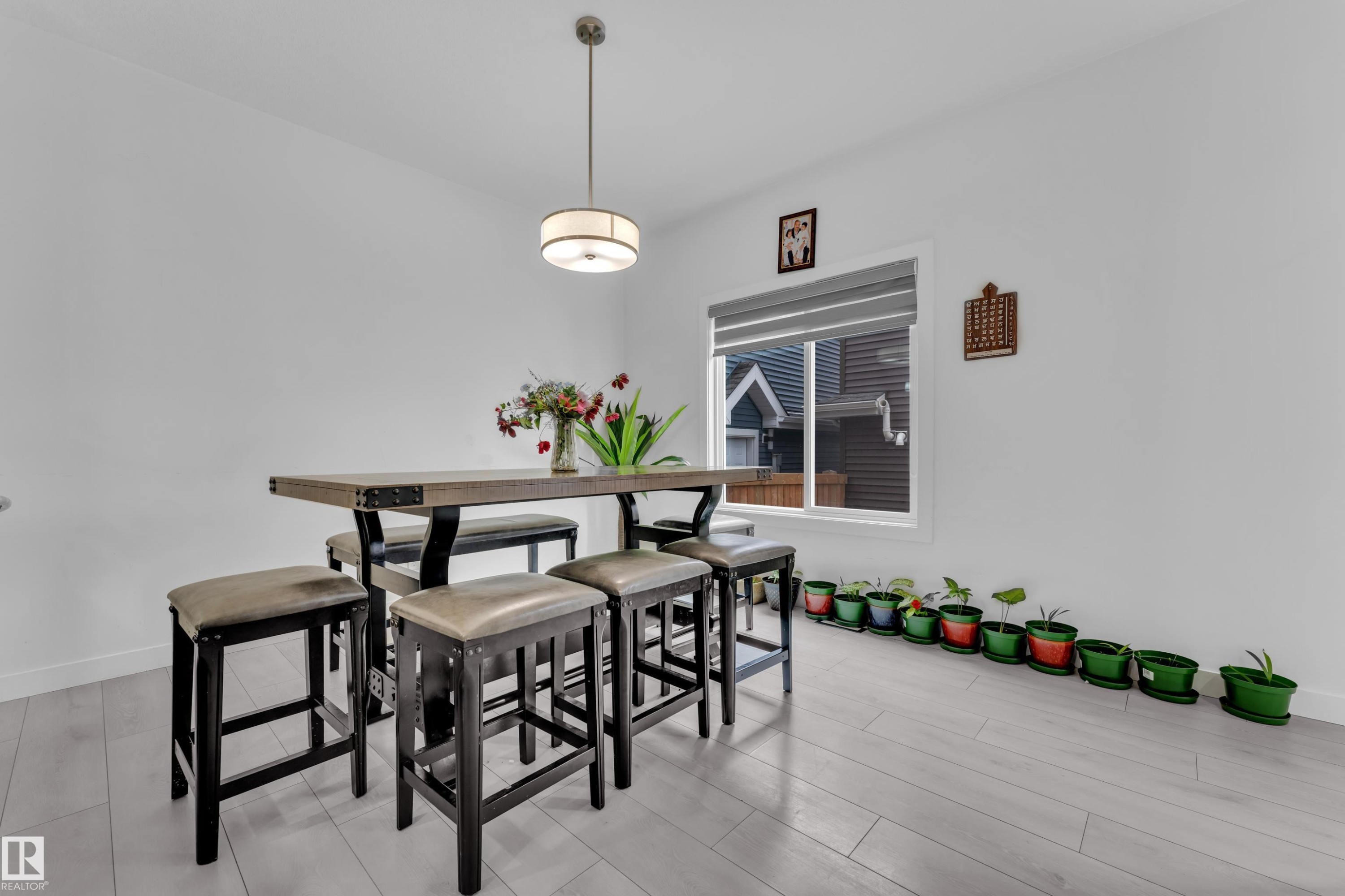 The property features light-toned flooring, a window, and a ceiling light fixture - 1645 Plum Circle, Edmonton, AB - Indoor Photo Showing Dining Room