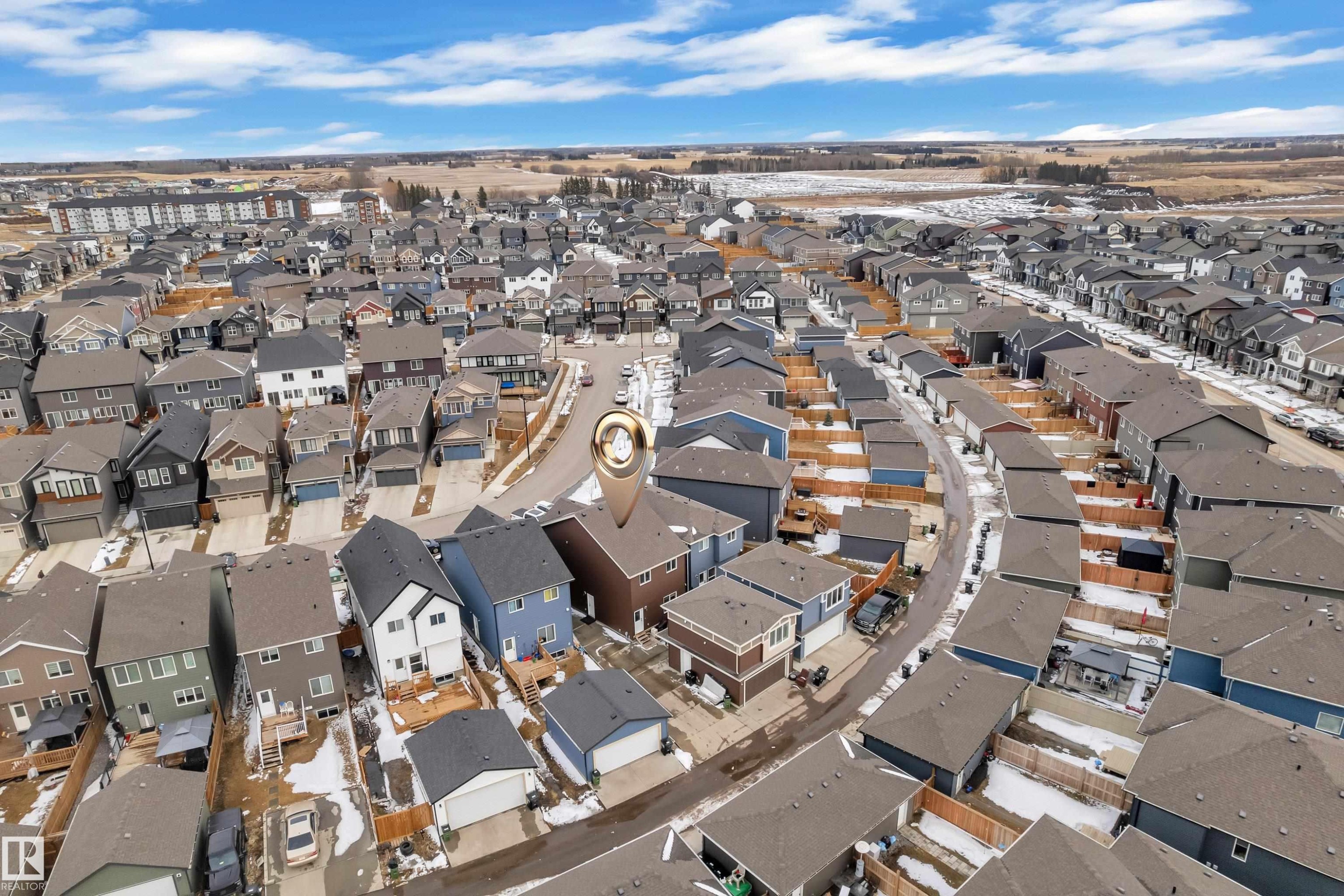 Aerial view of the residential property, surrounded by other residential properties, featuring a clear sky with scattered clouds - 1645 Plum Circle, Edmonton, AB - Outdoor With View