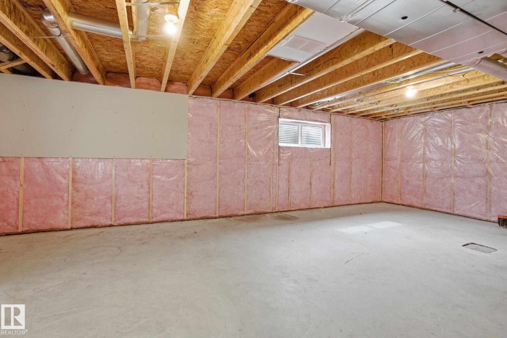 Expansive unfinished space with exposed wood joists, a concrete floor, and insulated walls - 1607 202 Street, Edmonton, AB - Indoor Photo Showing Basement