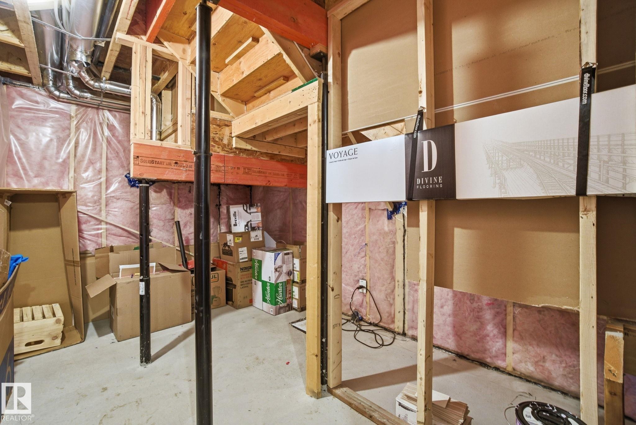 The property features exposed wooden framing, ductwork, and insulation, indicating potential for customization - 1607 202 Street, Edmonton, AB - Indoor Photo Showing Basement