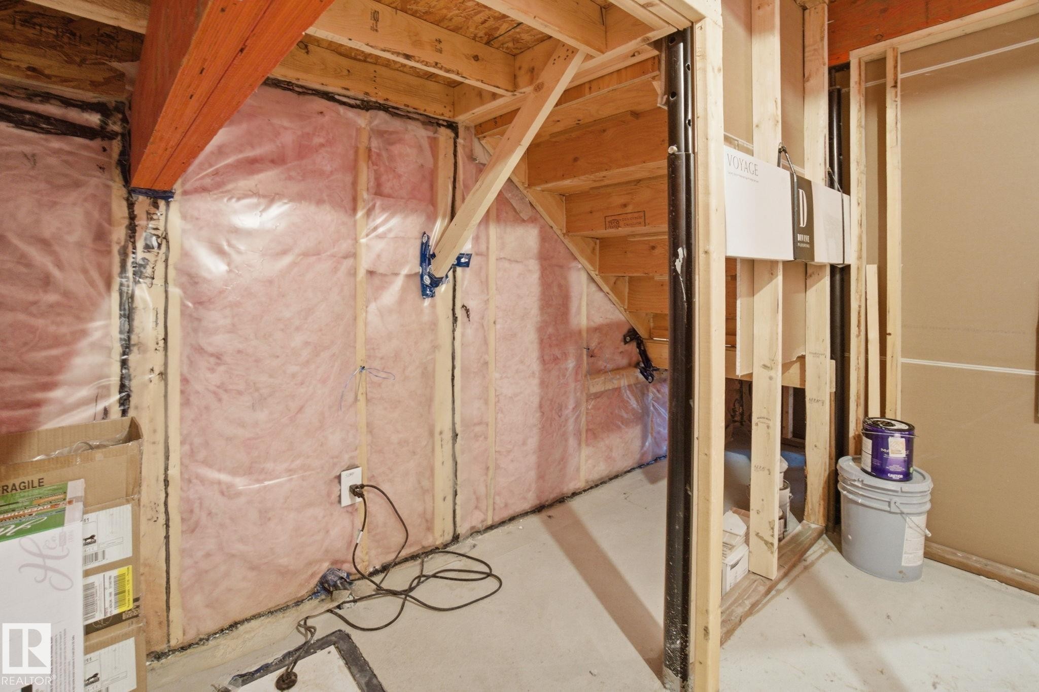 The property features an unfinished basement with exposed wooden framing and insulation - 1607 202 Street, Edmonton, AB - Indoor Photo Showing Basement