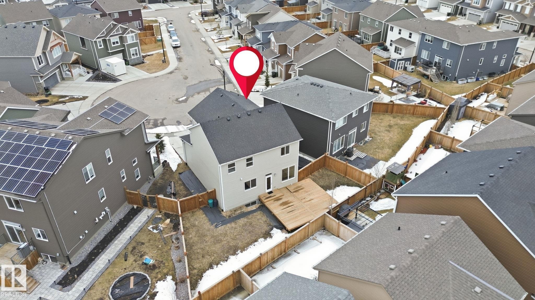 This property features a two-story exterior with a deck and fenced yard - 1607 202 Street, Edmonton, AB -