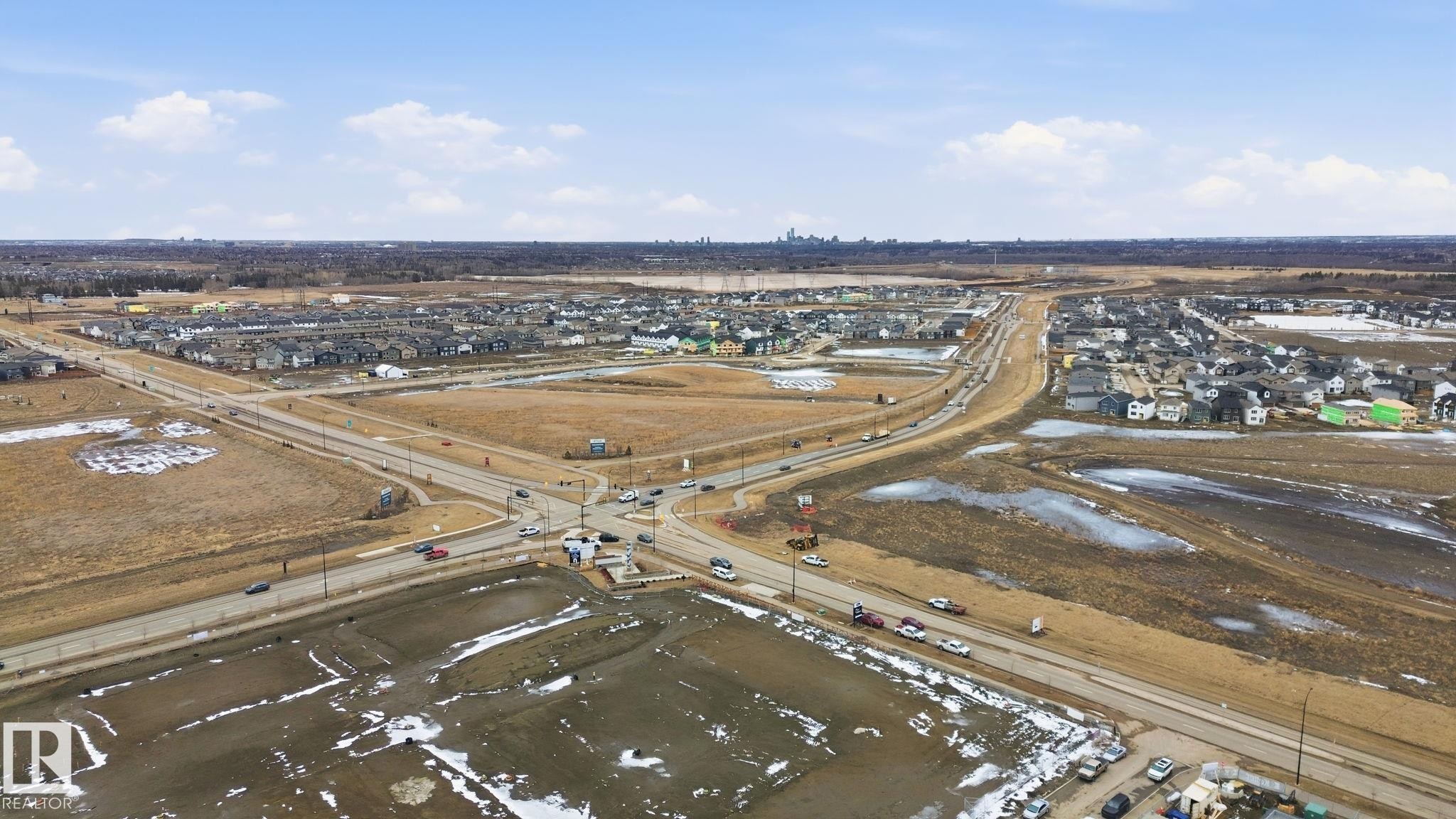 Aerial view of the surrounding neighborhood showcasing houses, roads, and open land - 1607 202 Street, Edmonton, AB - Outdoor With View