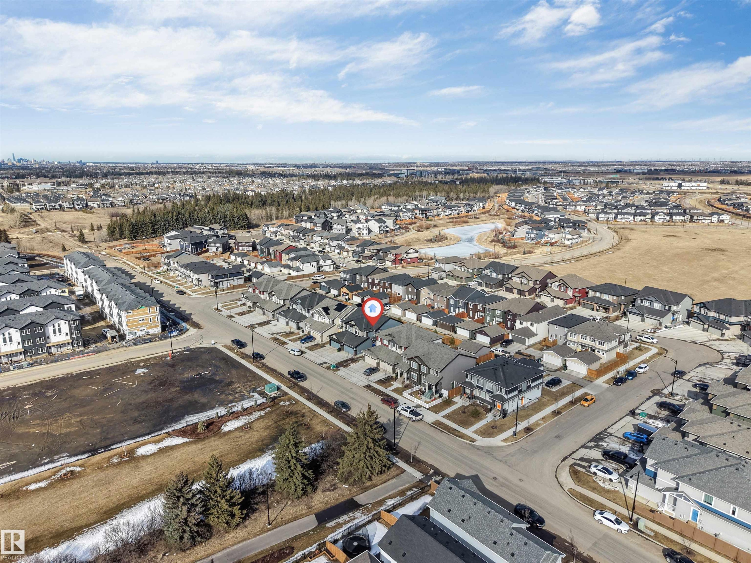 Aerial view of the surrounding neighbourhood, featuring residential streets, houses, and undeveloped land - 1663 Cavanagh Boulevard Sw, Edmonton, AB - Outdoor With View
