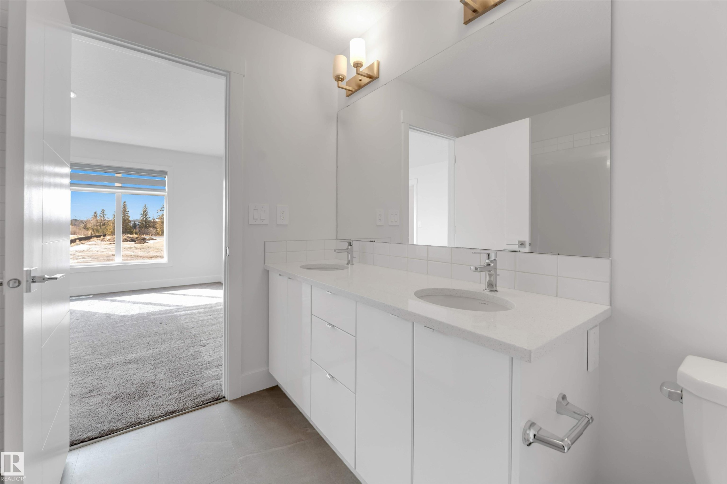 Bathroom vanity featuring a double sink, white cabinetry, and a large mirror - 1663 Cavanagh Boulevard Sw, Edmonton, AB - Indoor Photo Showing Bathroom