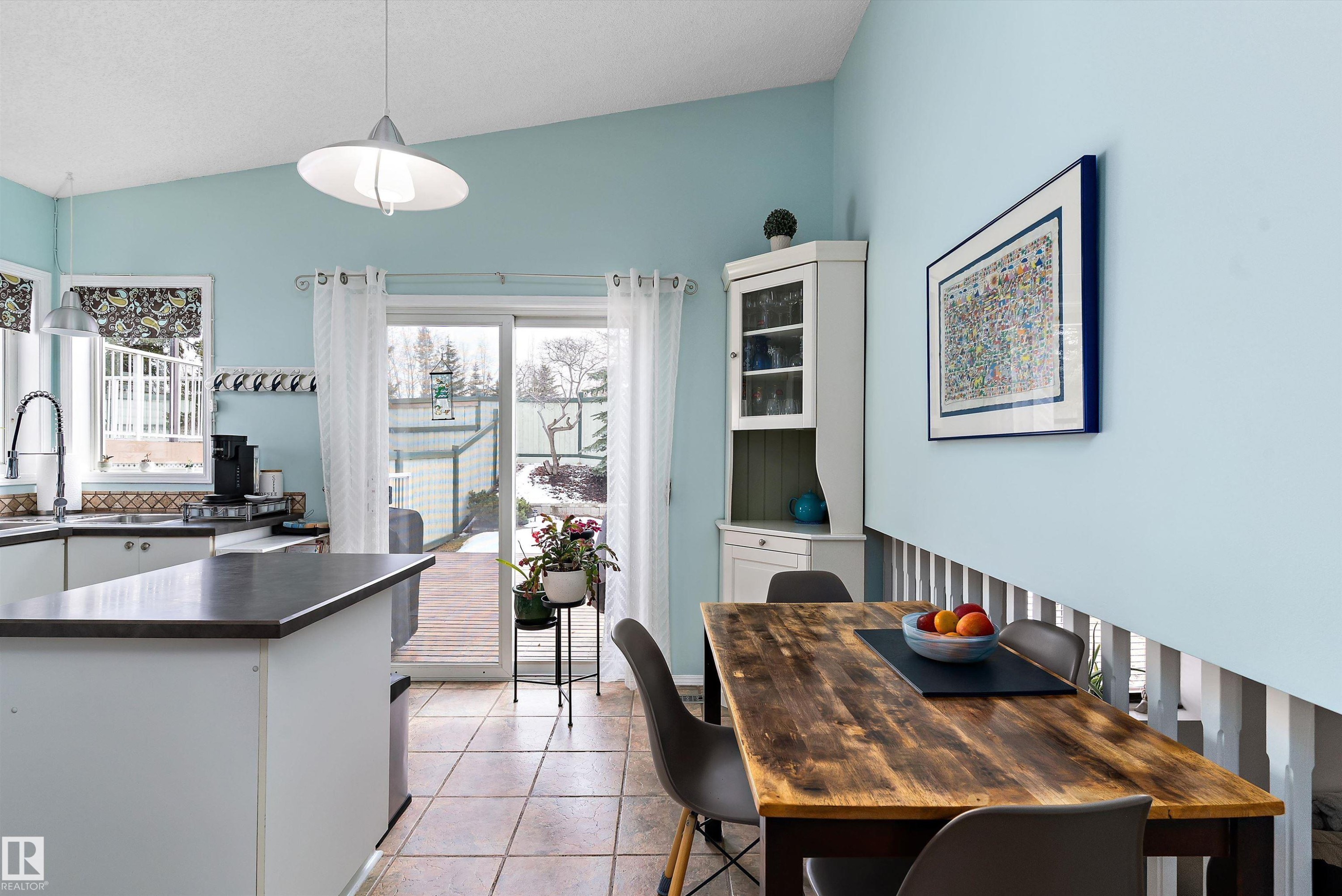 The dining area features a wooden table and a corner cabinet with a glass front - 322 Pearson Crescent, Edmonton, AB - Indoor Photo Showing Dining Room