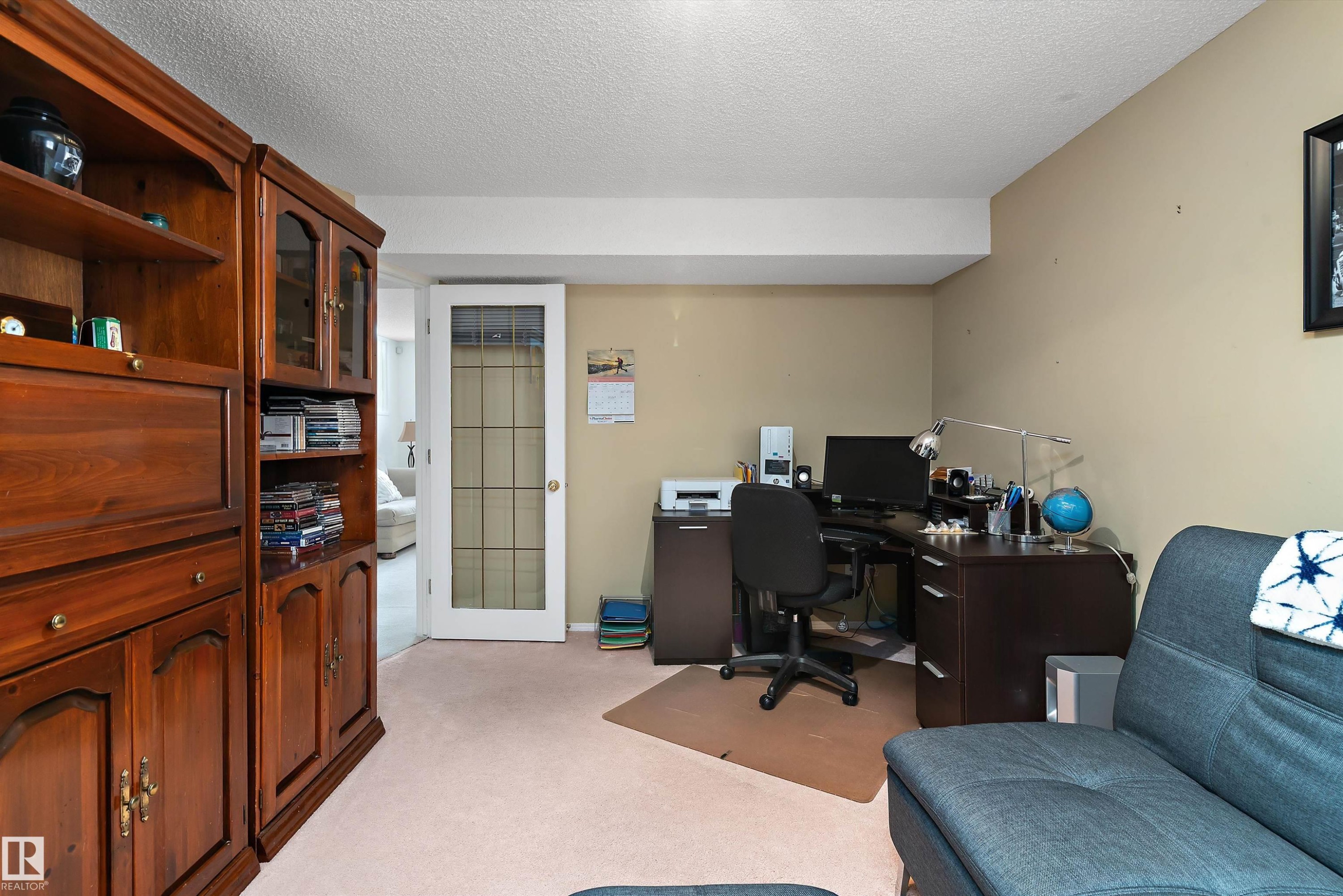 This room features a neutral color palette, a glass-paned door, and carpeted flooring - 322 Pearson Crescent, Edmonton, AB - Indoor Photo Showing Office