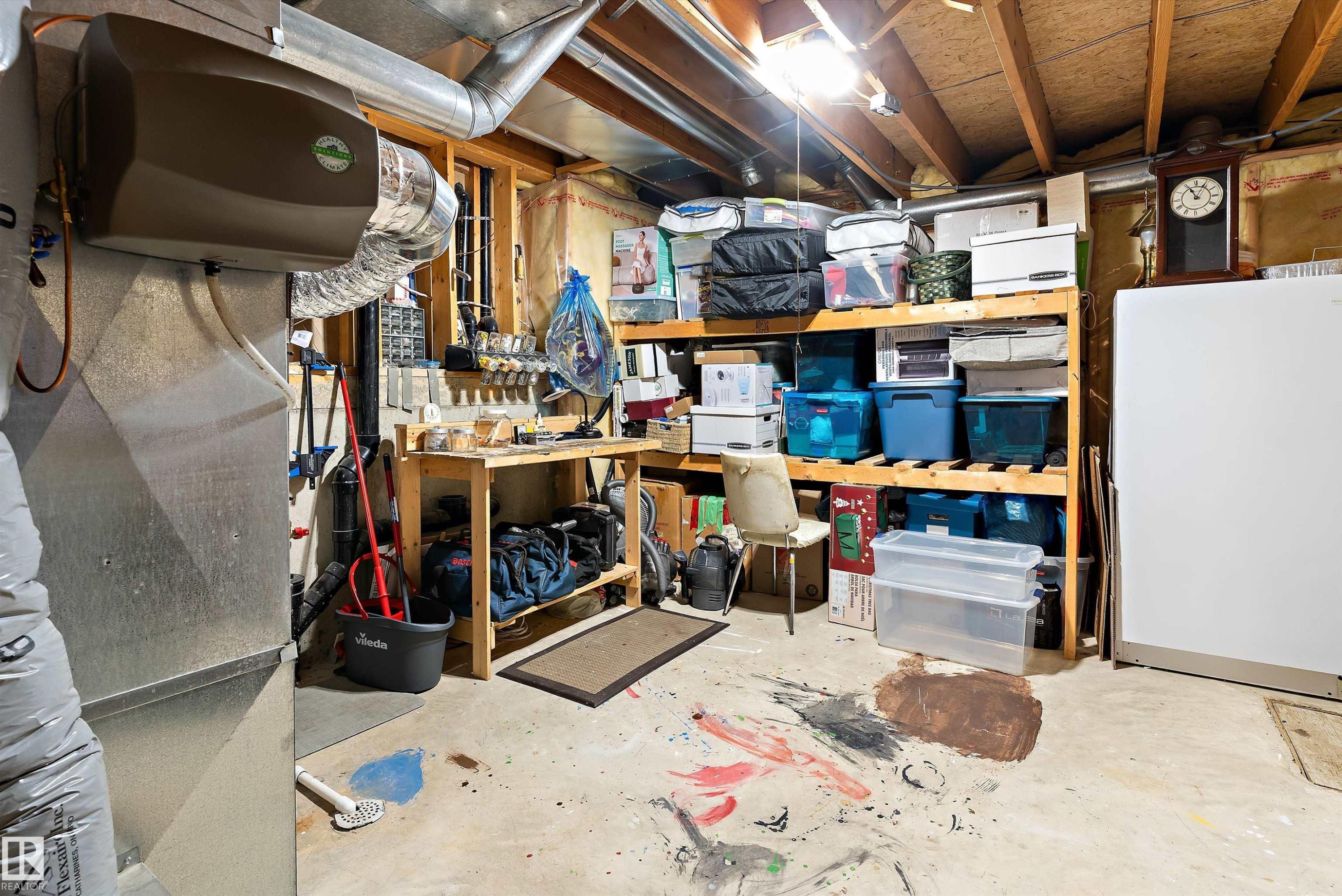 The property features a utility area with exposed ceiling joists and ductwork, illuminated by an overhead light - 322 Pearson Crescent, Edmonton, AB - Indoor Photo Showing Basement