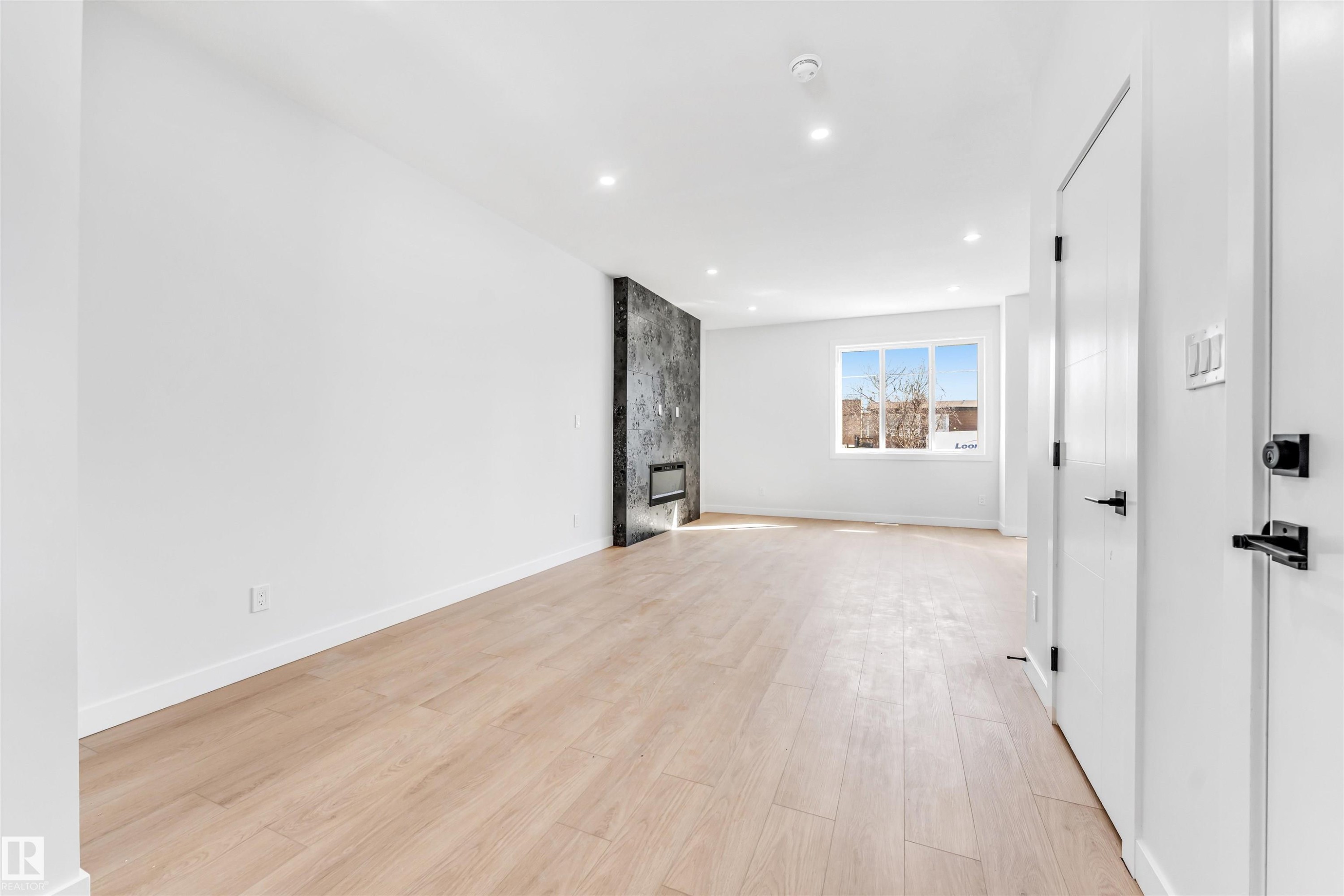 Open concept living area featuring light wood flooring and recessed lighting - 10962 157 Street, Edmonton, AB - Indoor Photo Showing Other Room