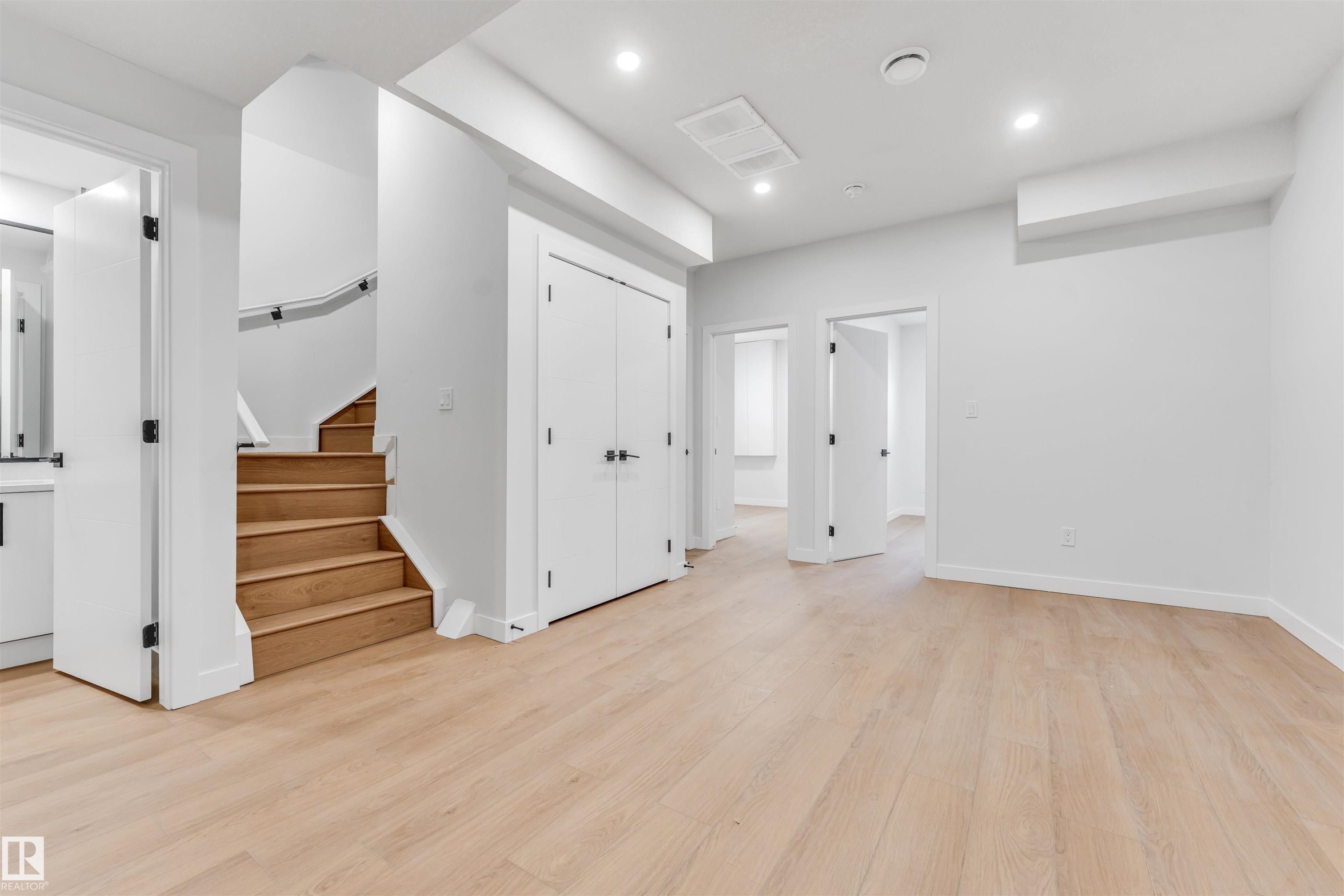 The property features light-toned hardwood flooring, white walls, and recessed lighting - 10962 157 Street, Edmonton, AB - Indoor Photo Showing Other Room