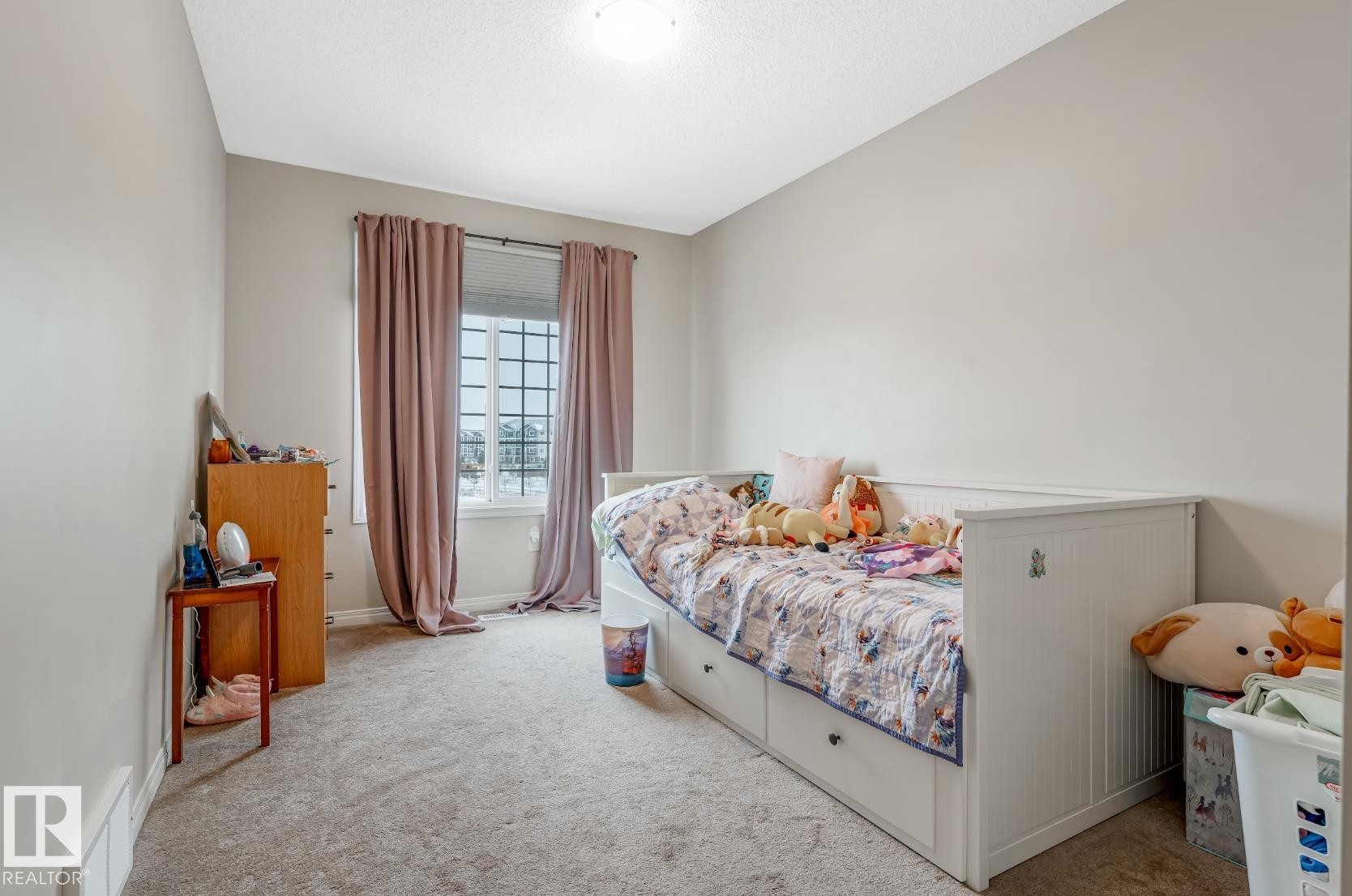 This room features light-colored walls and a window with pink curtains - 3109 Carpenter Landing, Edmonton, AB - Indoor Photo Showing Bedroom