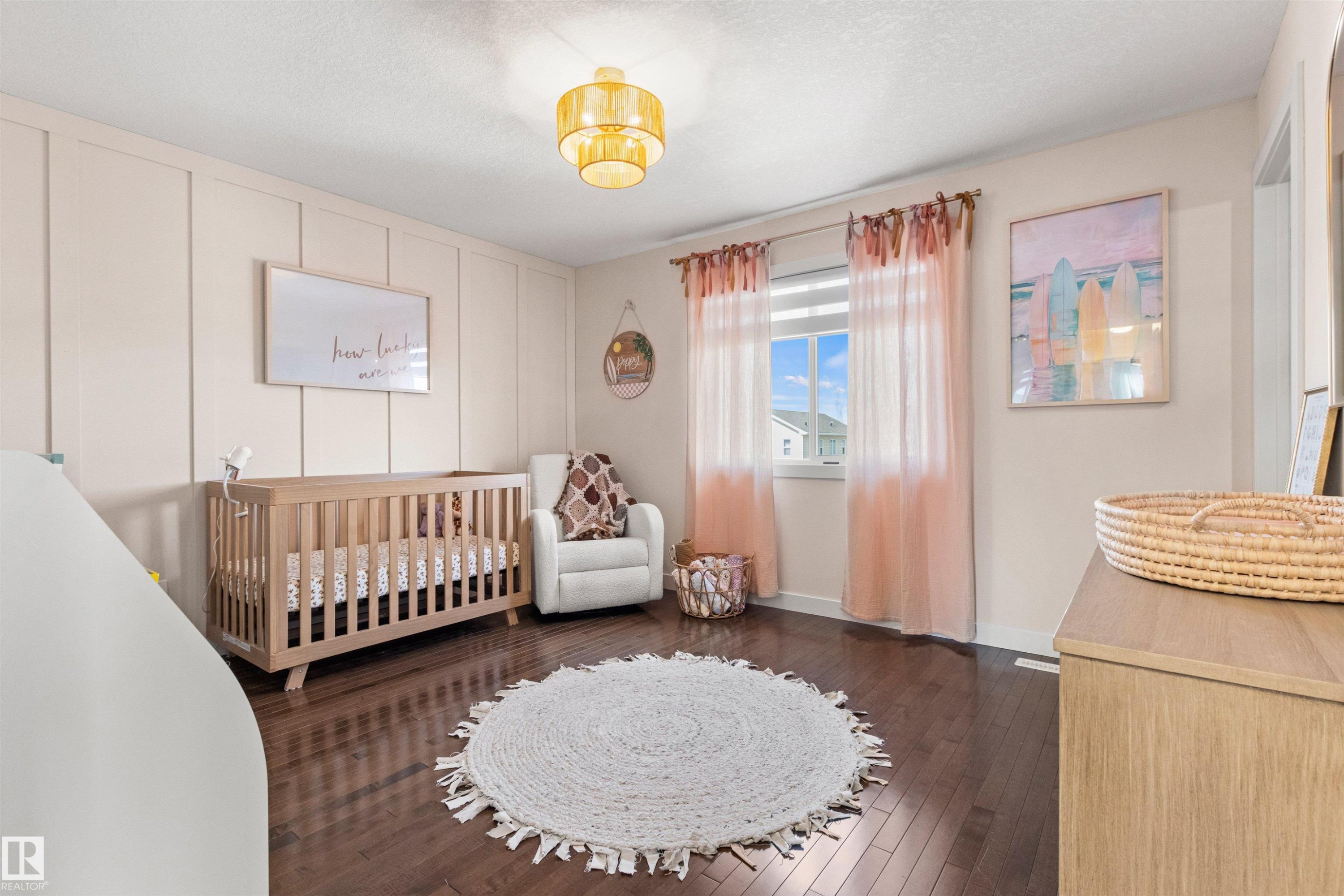 This room features dark wood flooring, a window with blinds and sheer curtains, and light-colored walls with vertical paneling detail - 38 Hewitt Circle, Spruce Grove, AB - Indoor Photo Showing Bedroom
