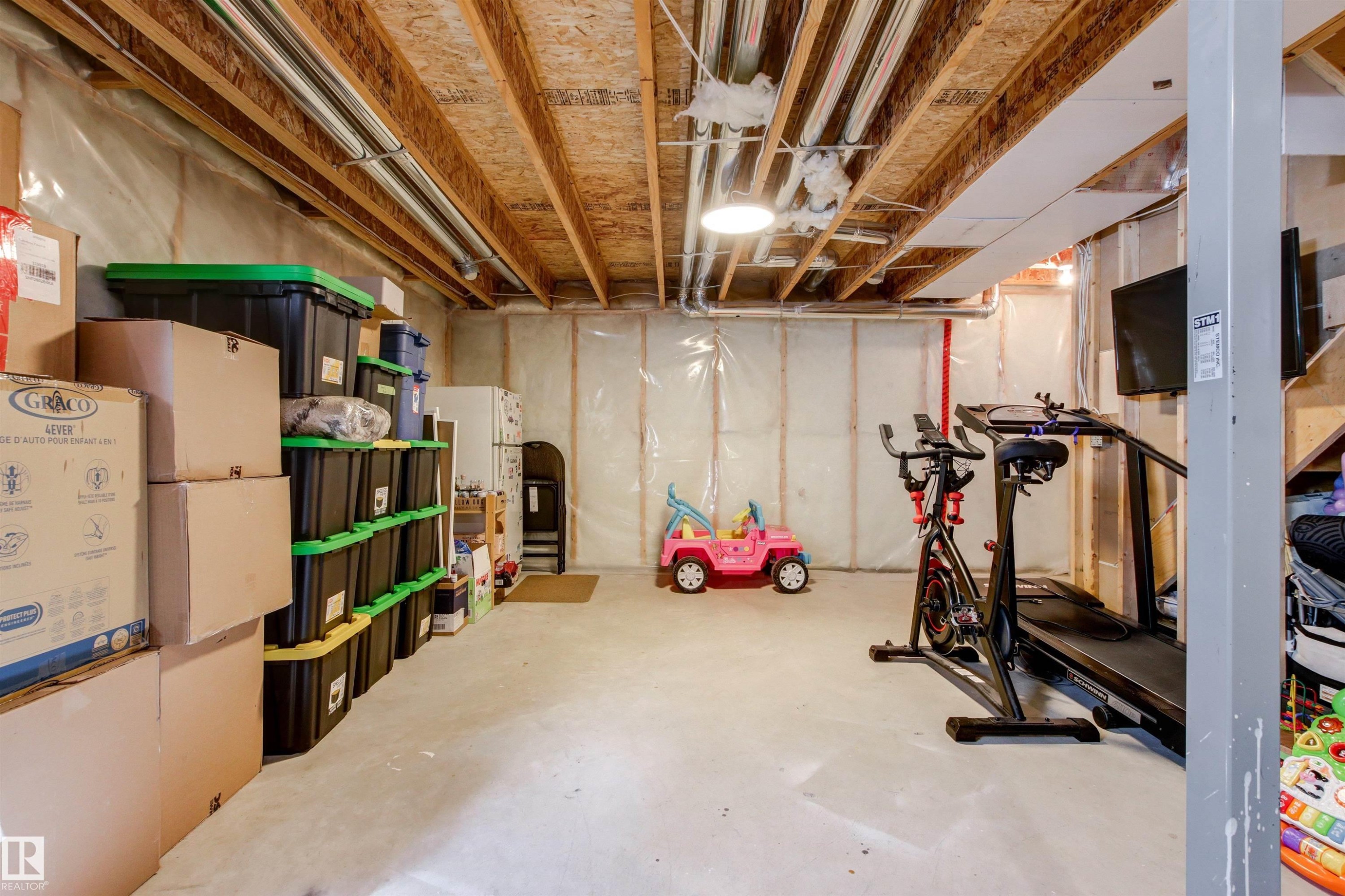 The property features a spacious, unfinished basement with exposed wooden joists and concrete flooring - 38 Hewitt Circle, Spruce Grove, AB - Indoor Photo Showing Basement