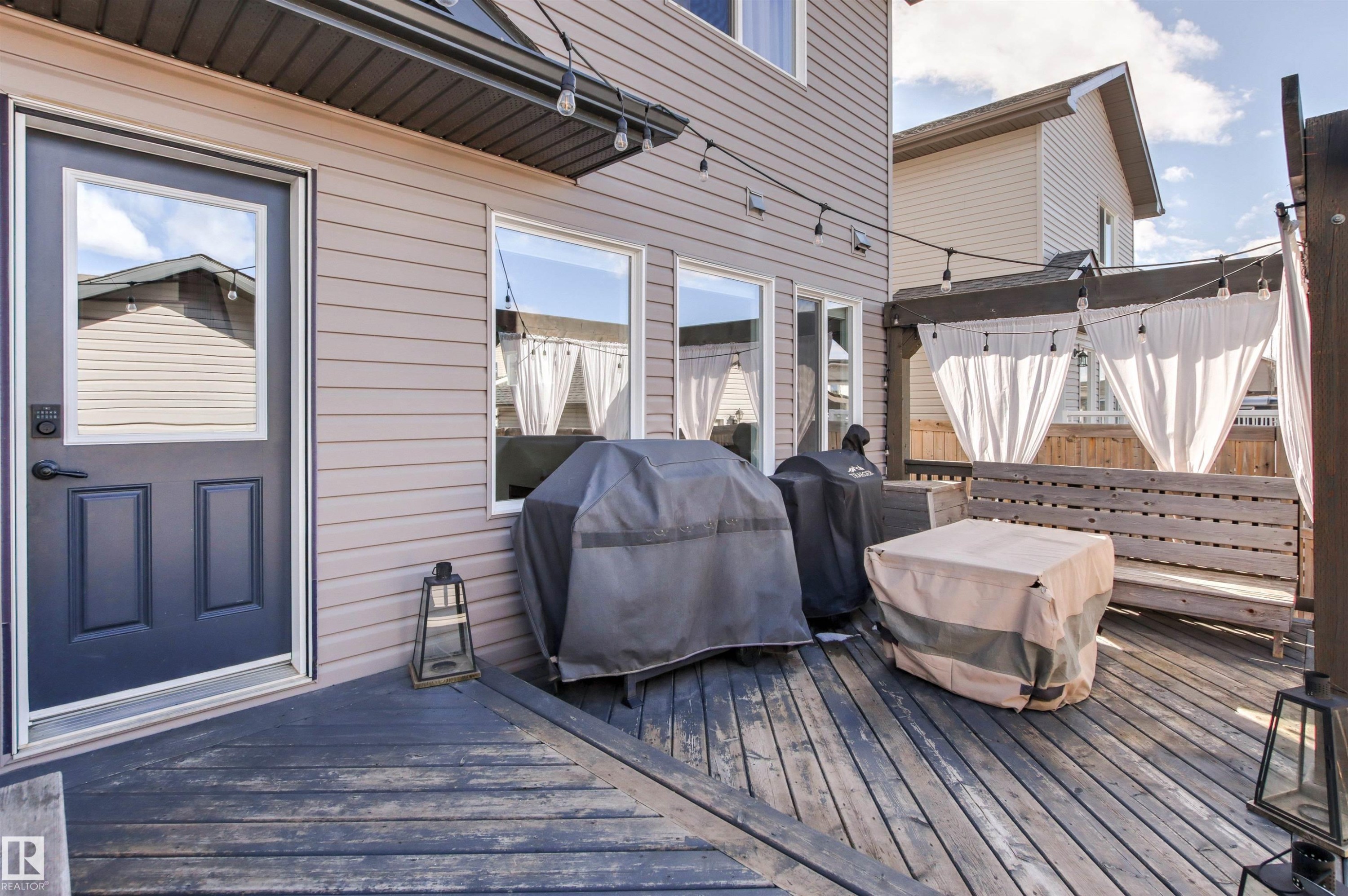 The property features an outdoor wooden deck, providing an inviting space for relaxation - 38 Hewitt Circle, Spruce Grove, AB - Outdoor With Deck Patio Veranda With Exterior