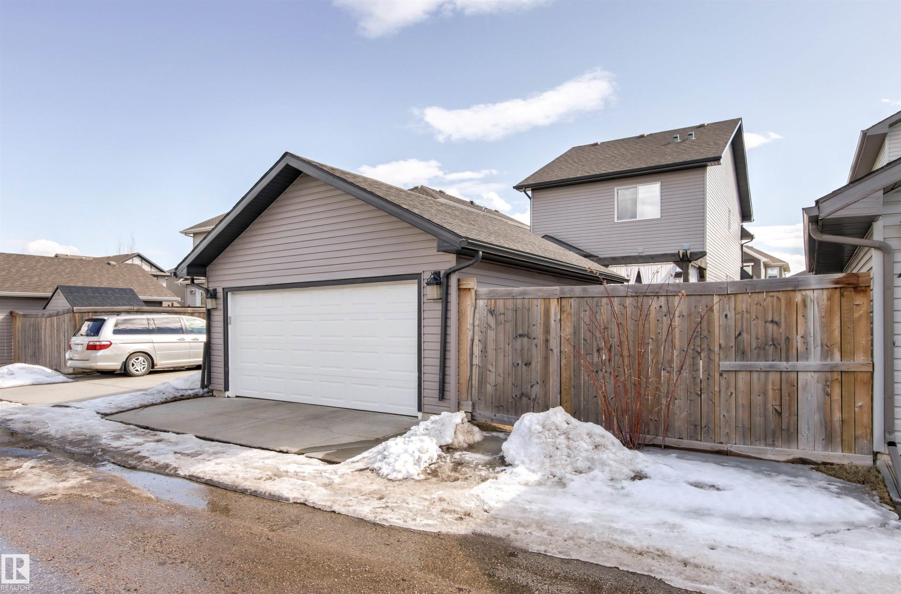 Detached garage with a white garage door and a concrete driveway - 38 Hewitt Circle, Spruce Grove, AB - Outdoor With Exterior