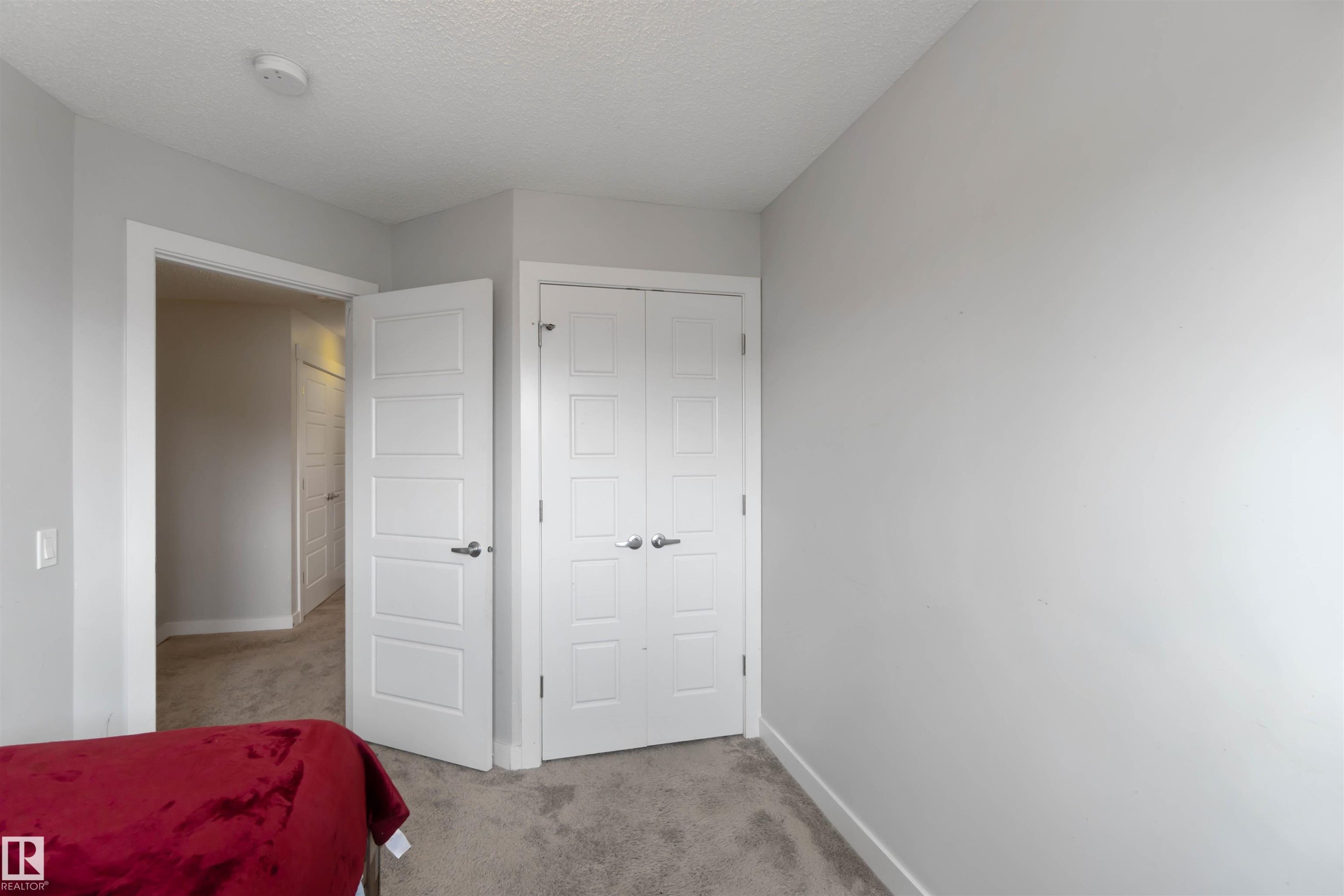 This room features light grey walls, a grey carpeted floor, and white trim - 2725 Orchards Road, Edmonton, AB - Indoor