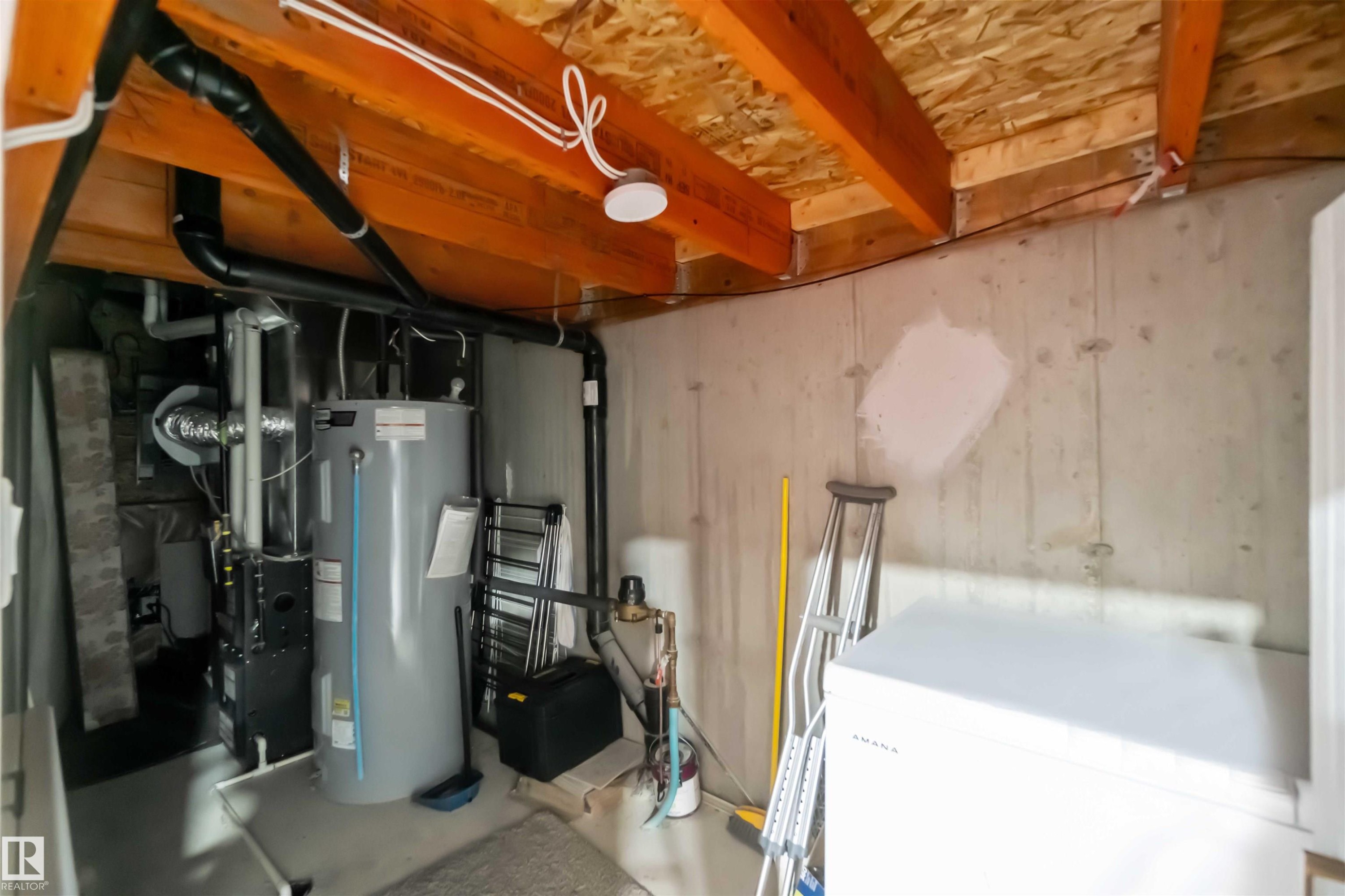 Utility area with exposed ceiling joists and concrete walls - 2725 Orchards Road, Edmonton, AB - Indoor Photo Showing Basement