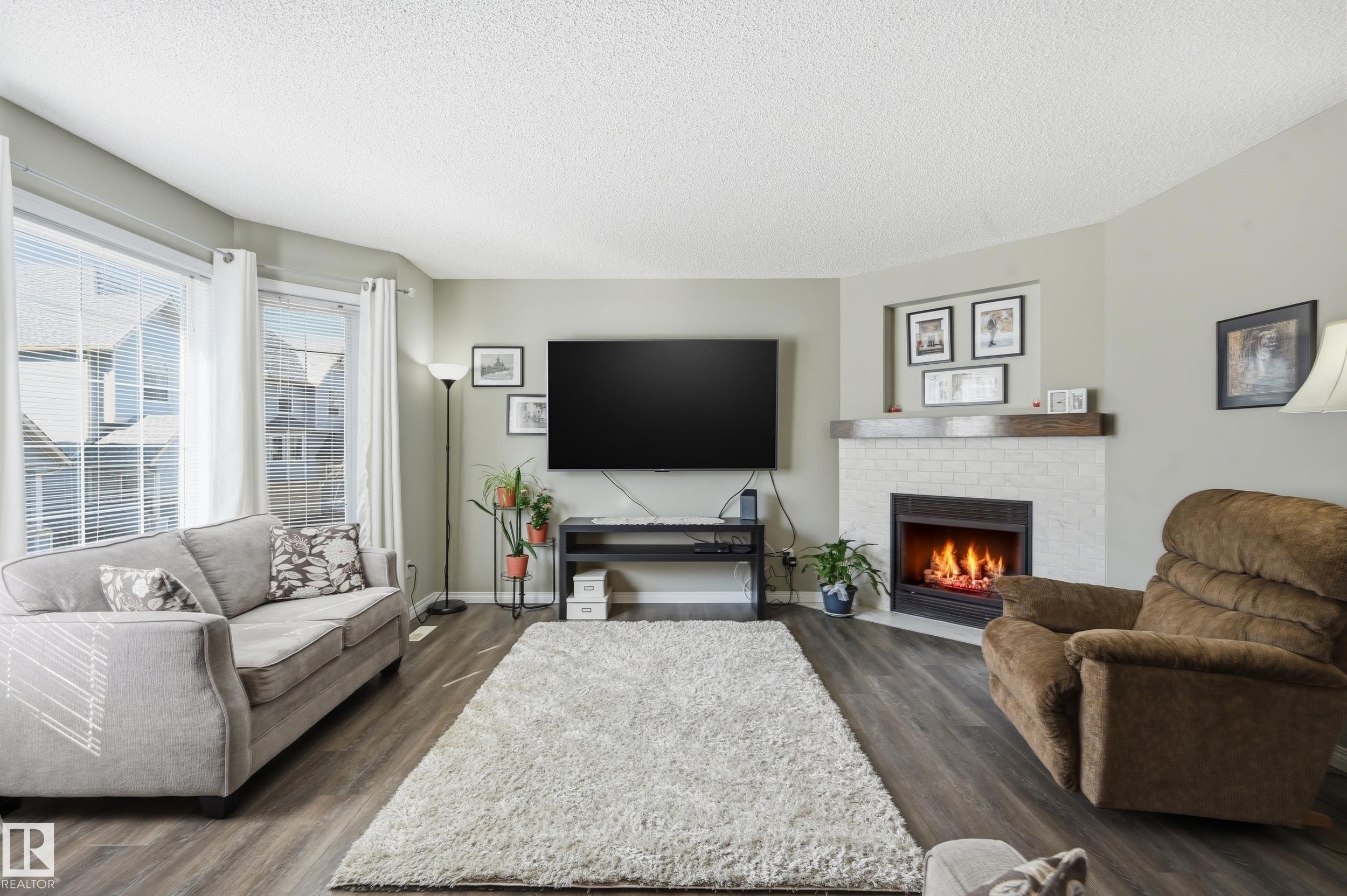 109 1670 Jamha Road Nw, Edmonton, AB - Indoor Photo Showing Living Room With Fireplace
