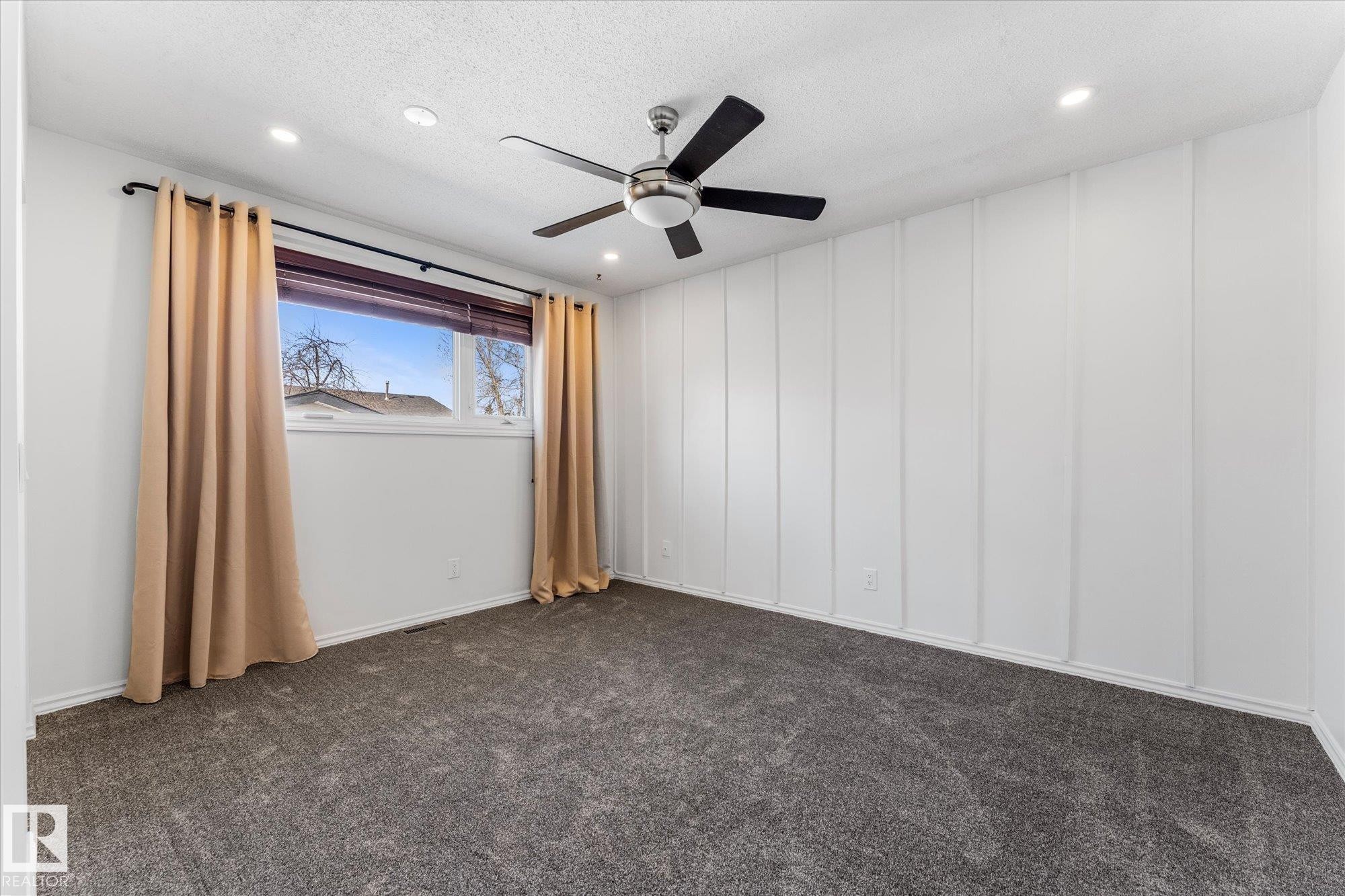 This room features plush grey carpeting, white paneled accent walls, and recessed lighting - 2626 49 Street, Edmonton, AB - Indoor Photo Showing Other Room