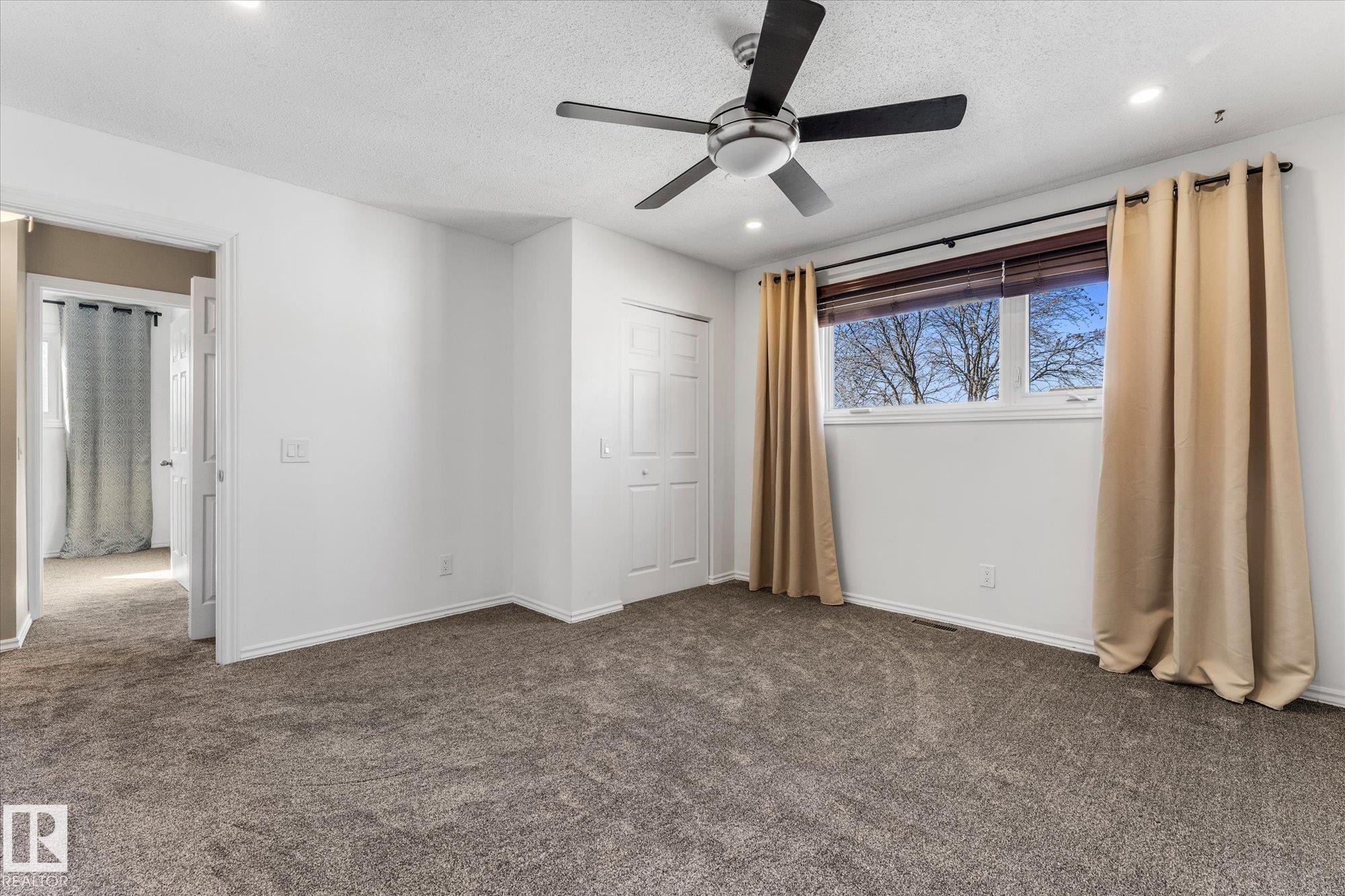 The room features carpeting, white walls, and a window providing natural light - 2626 49 Street, Edmonton, AB - Indoor Photo Showing Other Room