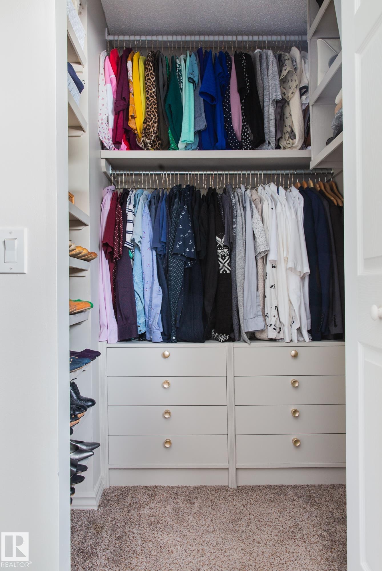 This closet features built-in shelving and hanging rods for ample storage, along with two sets of built-in drawers, each with four drawers and gold-toned knobs - 2626 49 Street, Edmonton, AB - Indoor With Storage