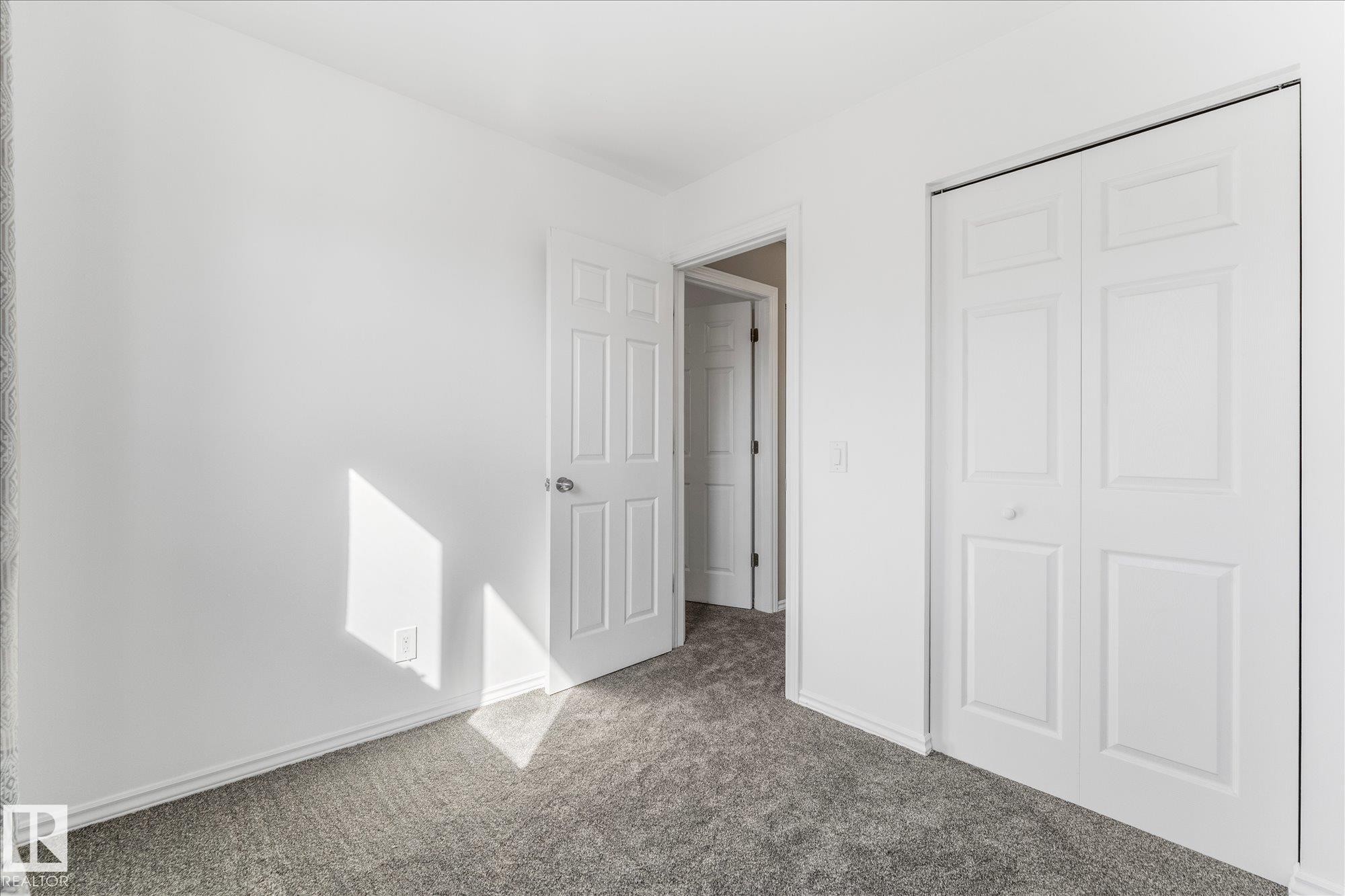 This room features light-colored walls and grey carpet flooring - 2626 49 Street, Edmonton, AB - Indoor Photo Showing Other Room