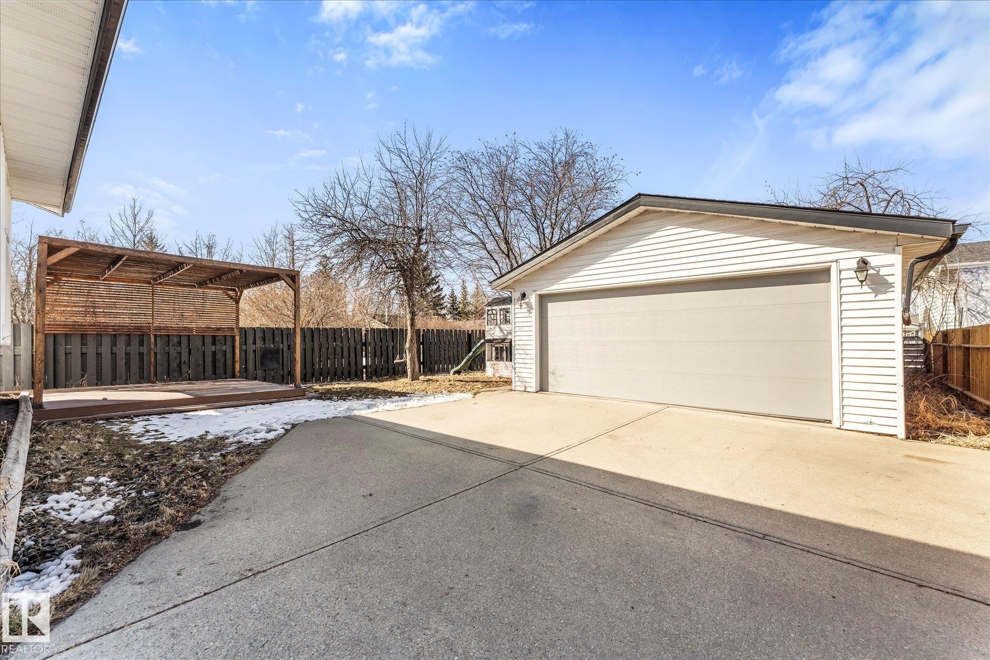 The property includes a detached garage with white siding and a light-colored garage door - 2626 49 Street, Edmonton, AB - Outdoor