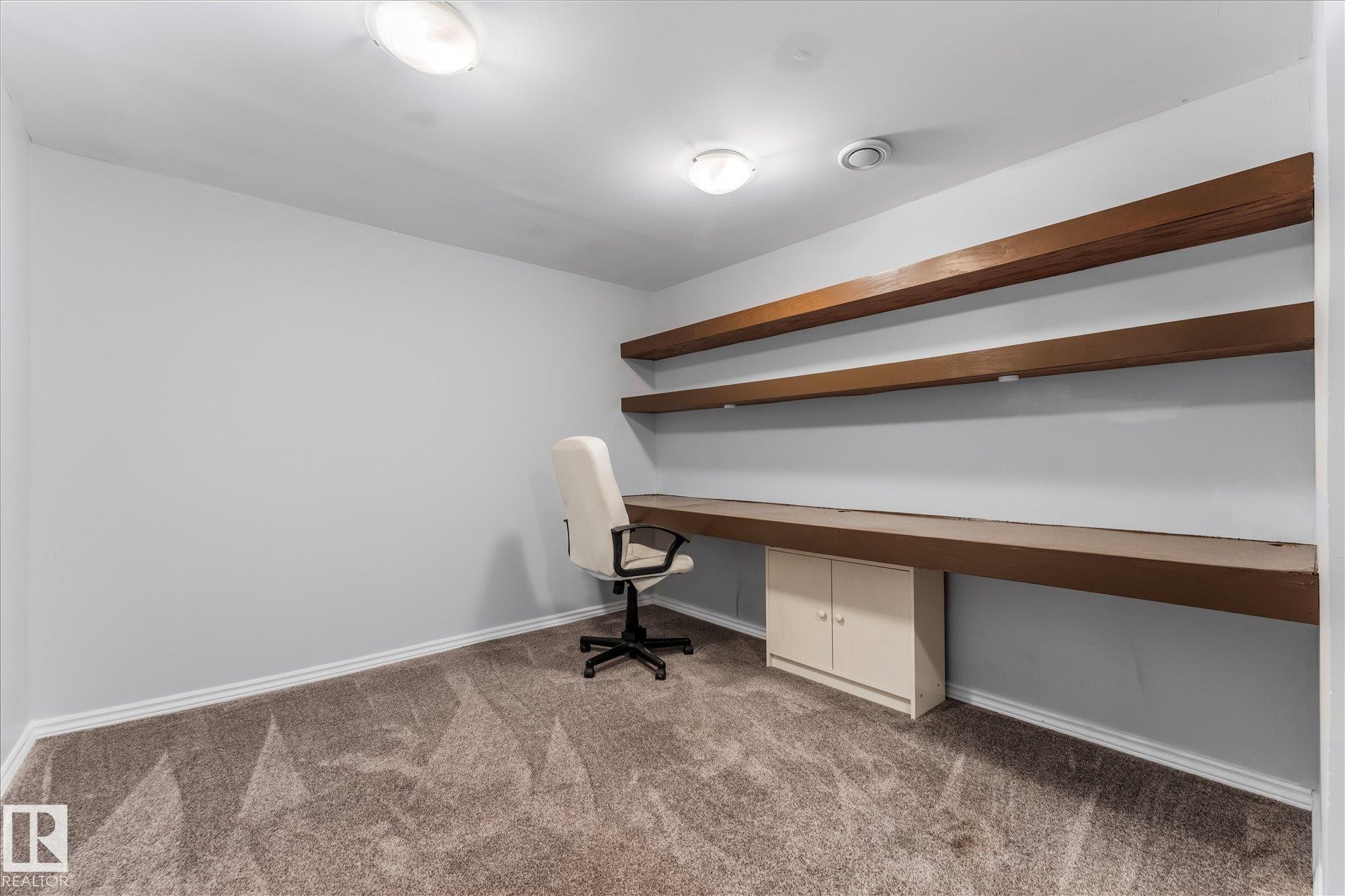 This room features grey walls, a built-in desk with a lower cabinet, and two upper shelves - 2626 49 Street, Edmonton, AB - Indoor