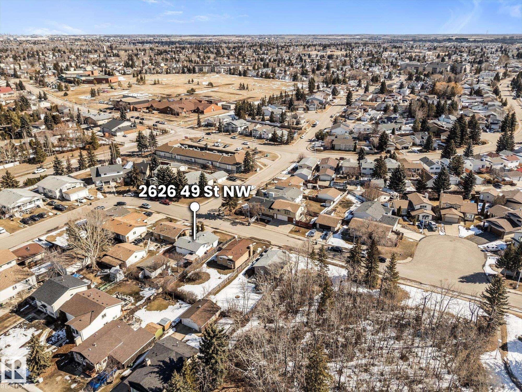 Aerial view of the surrounding neighborhood, featuring numerous residential properties with various roof styles and a clear sky overhead - 2626 49 Street, Edmonton, AB - Outdoor With View
