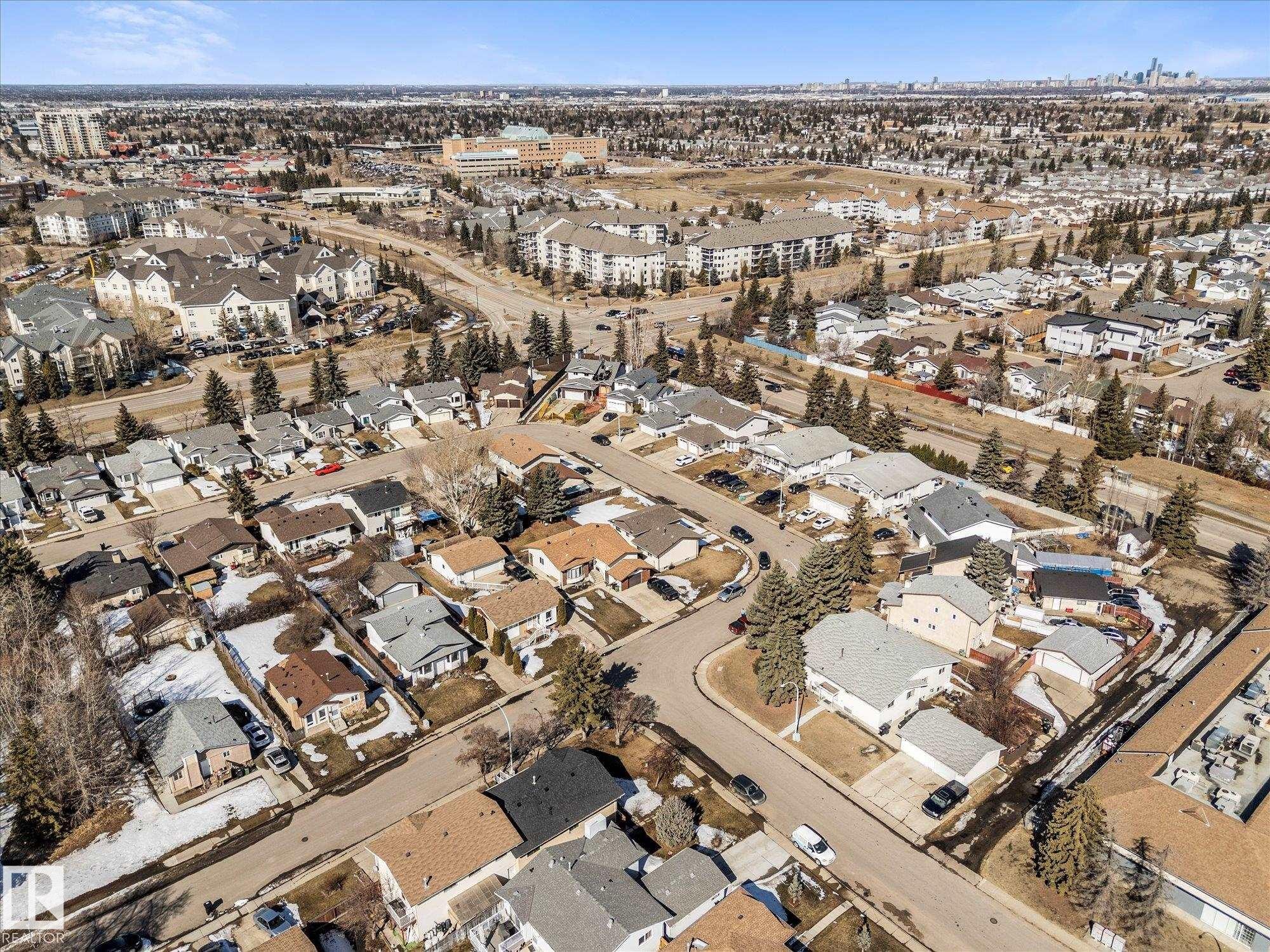 Aerial view showcasing the residential neighbourhood with a mix of single-story and multi-story homes, surrounded by green spaces and mature trees - 2626 49 Street, Edmonton, AB - Outdoor With View