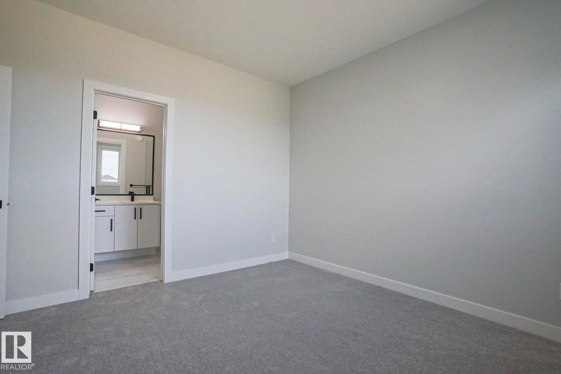 Interior room featuring light grey walls and grey carpet - Rural Leduc County, AB - Indoor Photo Showing Other Room