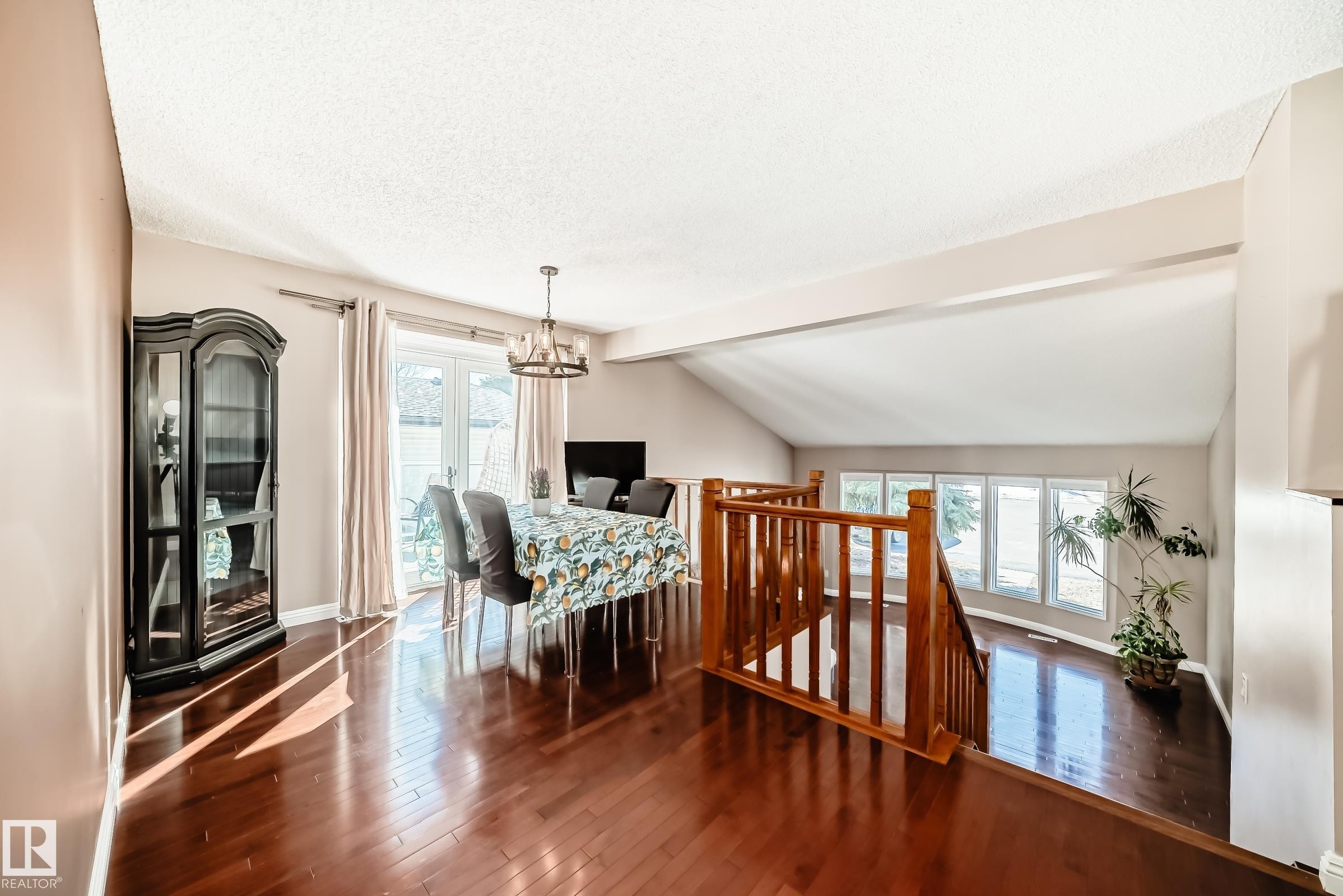 This inviting interior space features hardwood floors, a dining area with French doors leading outside, and a wooden staircase - 287 Lago Lindo Crescent, Edmonton, AB - Indoor