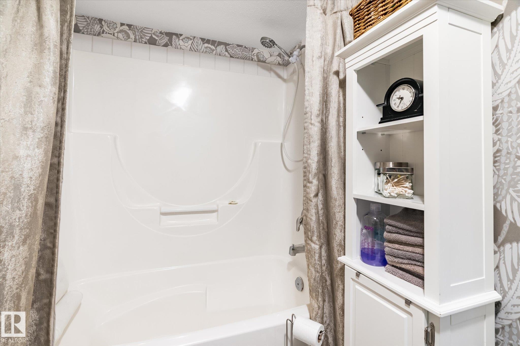 The bathroom features a white bathtub and shower combination with a shower head and faucet - 5 4902B 43 Street, Legal, AB