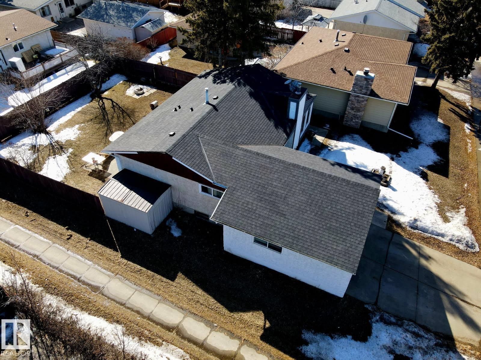 The property features a dark shingle roof and an exterior shed - 11323 162 Avenue, Edmonton, AB - Outdoor