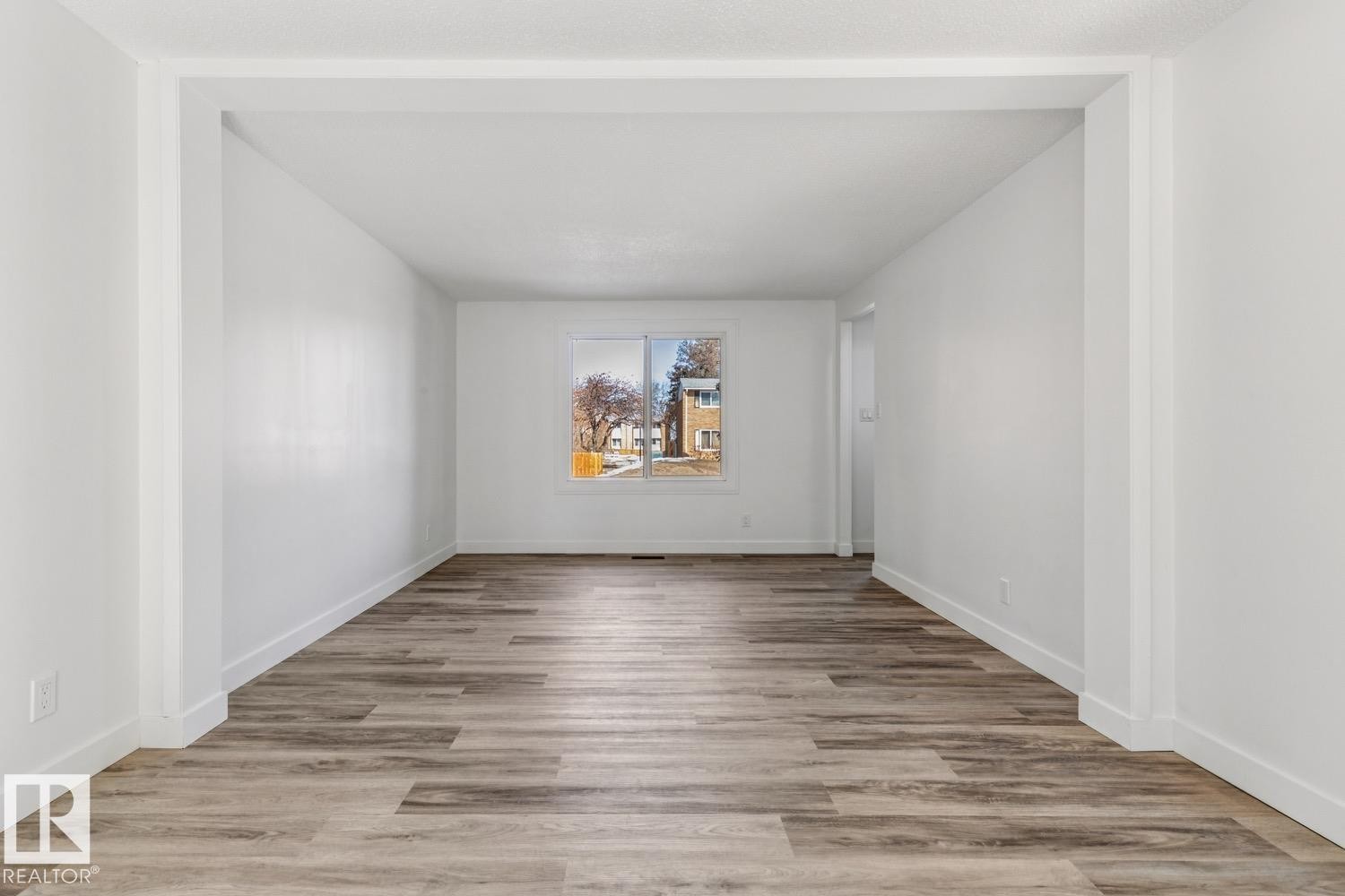 The interior features light wood-look flooring and white walls, creating a bright and open atmosphere - 95 Ridgewood Terrace, St. Albert, AB - Indoor Photo Showing Other Room