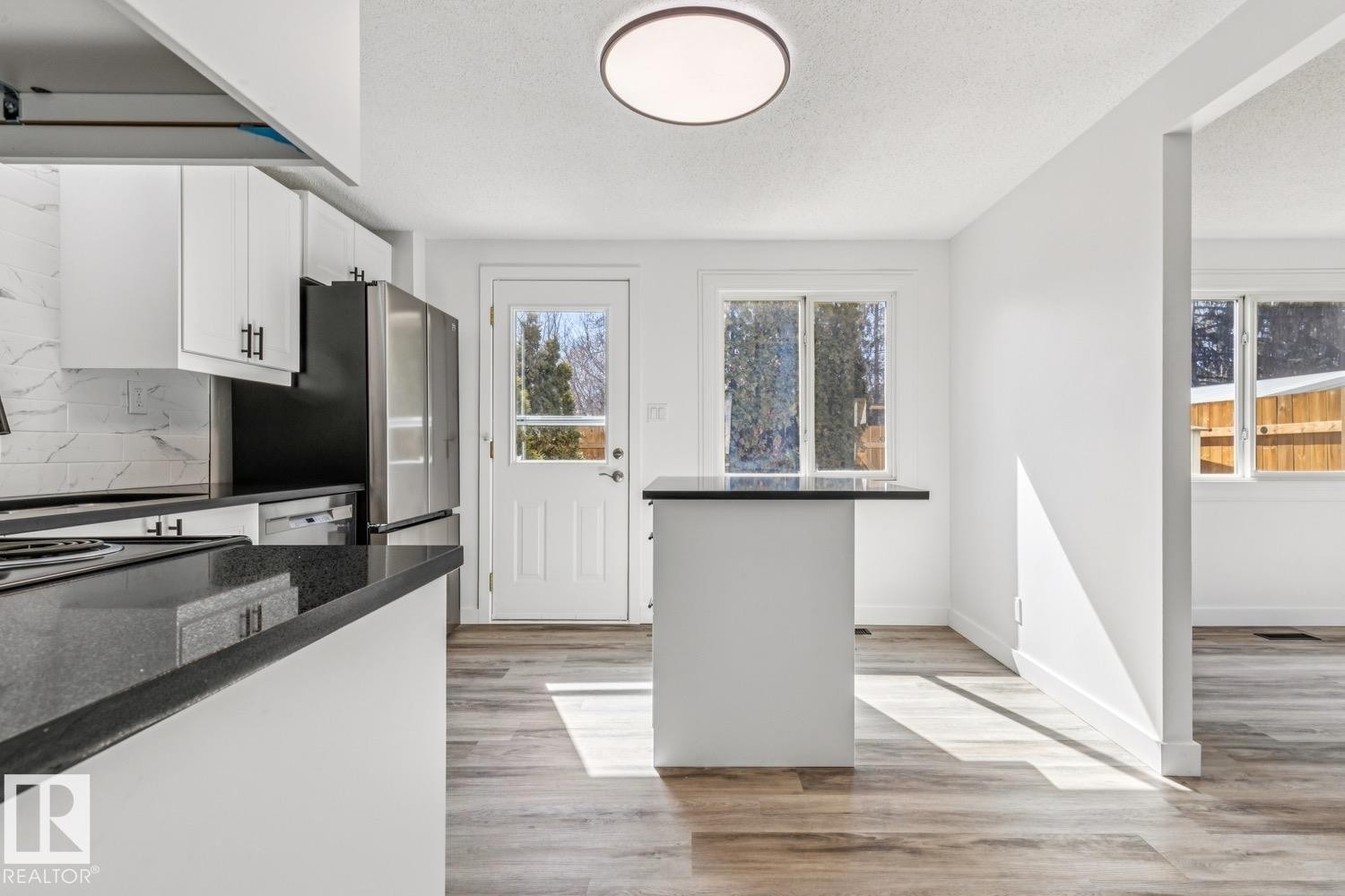 Kitchen with white cabinetry, dark countertops, and stainless steel appliances - 95 Ridgewood Terrace, St. Albert, AB - Indoor Photo Showing Kitchen