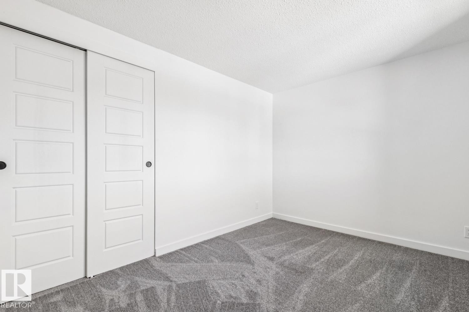 This room features a neutral color palette with white walls and a grey carpet - 95 Ridgewood Terrace, St. Albert, AB - Indoor Photo Showing Other Room