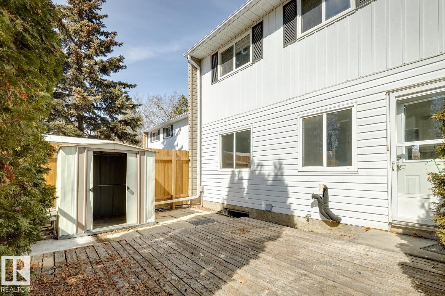 The property features a white exterior with horizontal siding and multiple windows - 95 Ridgewood Terrace, St. Albert, AB - Outdoor With Exterior