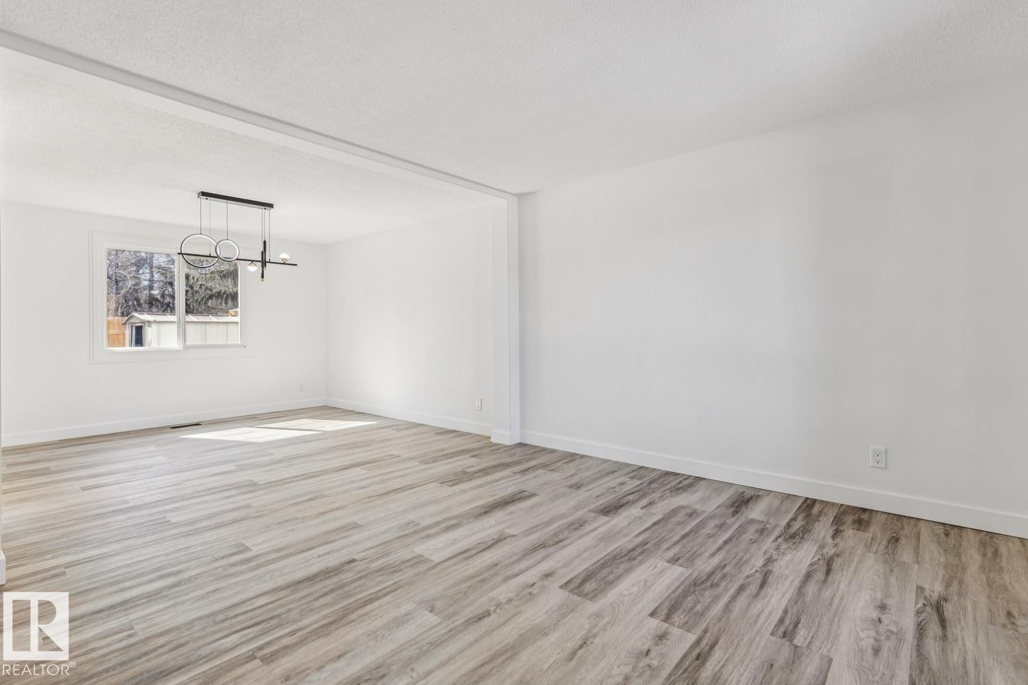 Spacious room featuring light-colored flooring, white walls, and a modern ceiling light fixture - 95 Ridgewood Terrace, St. Albert, AB - Indoor Photo Showing Other Room