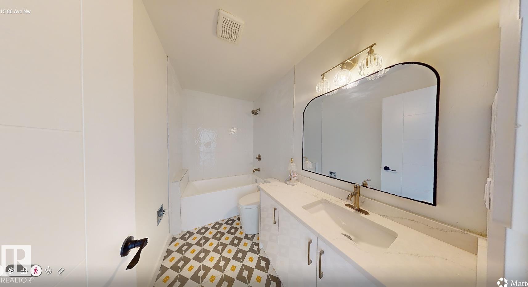 Bathroom featuring a white vanity with drawers, a white countertop, and a rectangular sink with a gold-toned faucet - 8515 86 Avenue, Edmonton, AB - Indoor