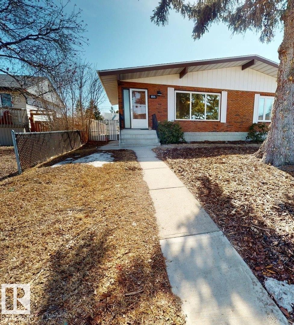 The property features a brick exterior with white trim and a front walkway leading to the entrance - 8515 86 Avenue, Edmonton, AB - Outdoor